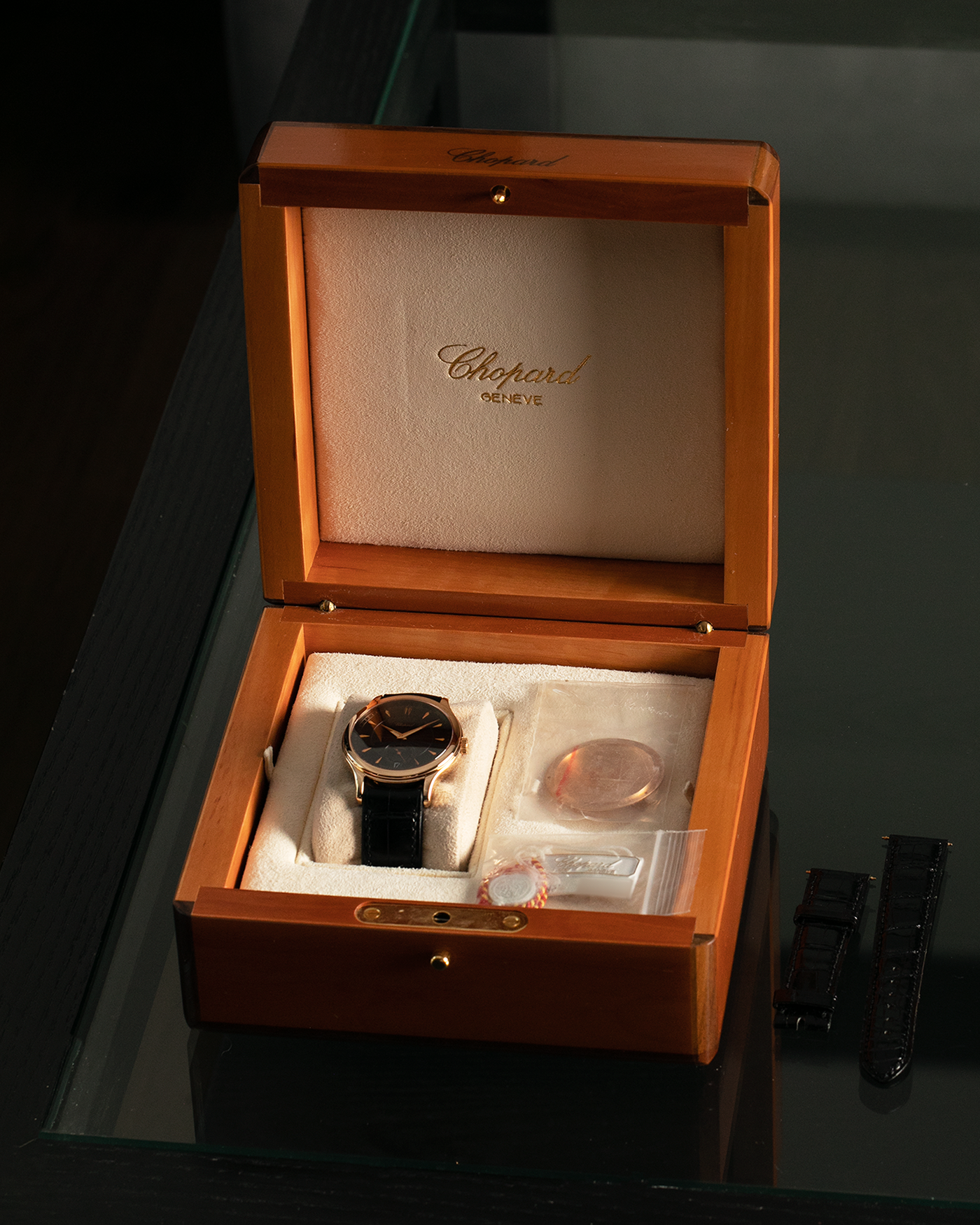 Brand: Chopard L.U.C.
Year: 1990’s
Model: 16/1860/2
Material: 18-carat Rose Gold
Movement: Chopard Cal. 1.96, Self-Winding Micro-Rotor
Case Diameter: 37mm x 8.5mm (Lug-to-Lug 45mm)
Lug Width: 18mm
Strap: Delugs Black Alligator Leather Strap with signed 18-carat Rose Gold Tang Buckle, extra Chopard Black Alligator Leather Strap