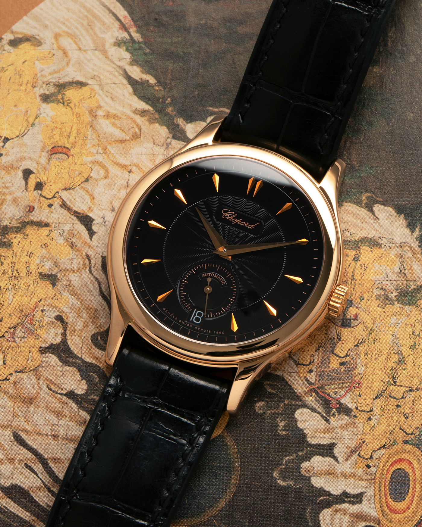 Brand: Chopard L.U.C.
Year: 1990’s
Model: 16/1860/2
Material: 18-carat Rose Gold
Movement: Chopard Cal. 1.96, Self-Winding Micro-Rotor
Case Diameter: 37mm x 8.5mm (Lug-to-Lug 45mm)
Lug Width: 18mm
Strap: Delugs Black Alligator Leather Strap with signed 18-carat Rose Gold Tang Buckle, extra Chopard Black Alligator Leather Strap