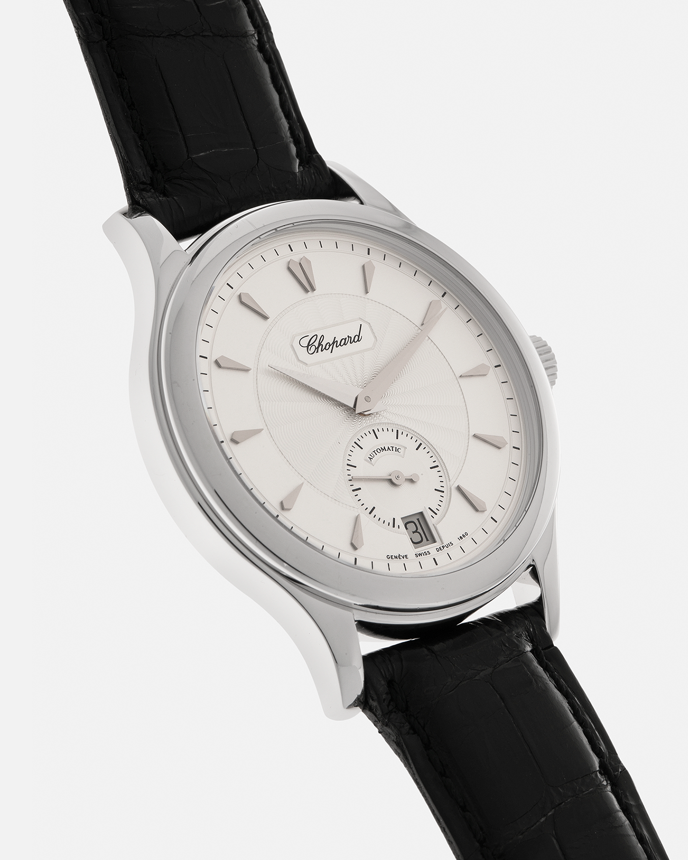 Brand: Chopard L.U.C.
Year: 1990’s
Model: 16/1860/2
Material: 18-carat White Gold
Movement: Chopard Cal. 1.96, Self-Winding Micro-Rotor
Case Dimensions: 37mm x 8.5mm (Lug-to-Lug 45mm)
Lug Width: 18mm
Strap: Chopard Black Alligator Leather Strap with Signed 18-carat White Gold Tang Buckle