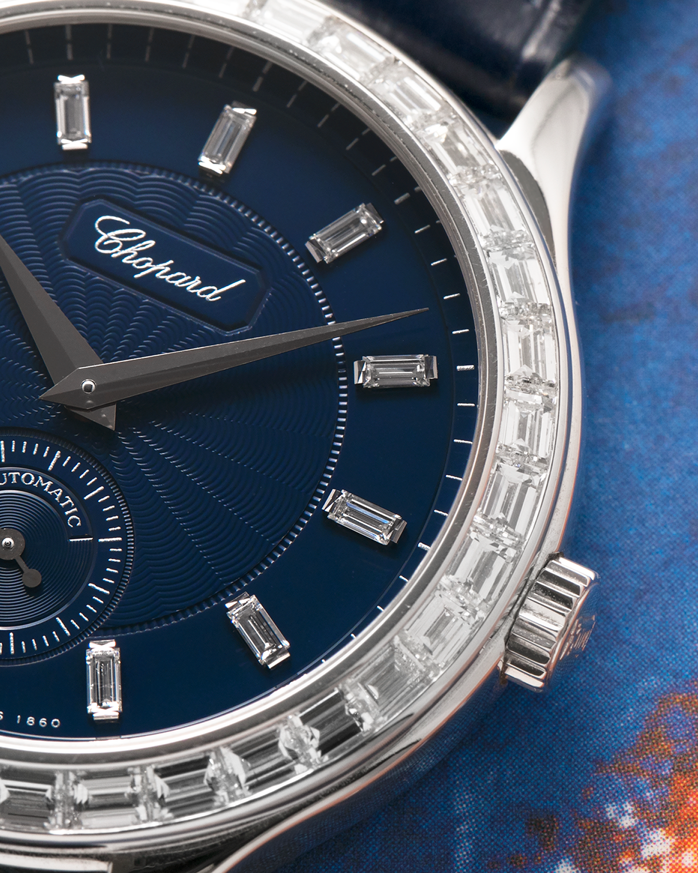 Brand: Chopard L.U.C.
Year: 2000’s
Model: 16/1864/2 Based Off 16/1860/2
Material: 18-carat White Gold Case, Factory-Set Baguette Diamond Bezel and Dial
Movement: Chopard Cal. 1.96, Self-Winding Micro-Rotor
Case Dimensions: 37mm Diameter 8.5mm Thickness
Lug Width: 18mm
Strap: Custom Order Blue Alligator Leather Strap with 18k White Gold Chopard Tang Buckle