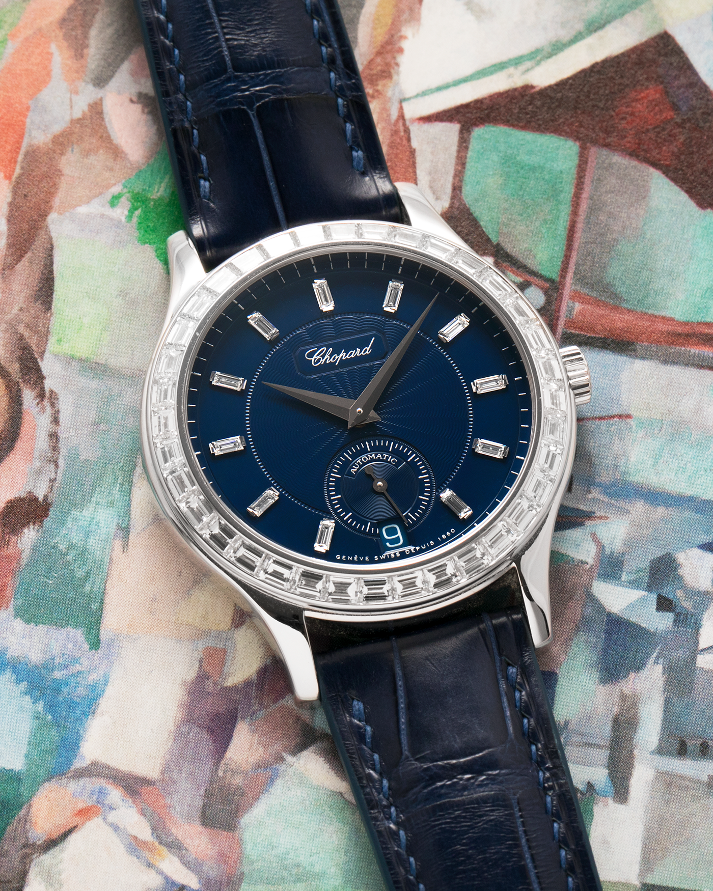 Brand: Chopard L.U.C.
Year: 2000’s
Model: 16/1864/2 Based Off 16/1860/2
Material: 18-carat White Gold Case, Factory-Set Baguette Diamond Bezel and Dial
Movement: Chopard Cal. 1.96, Self-Winding Micro-Rotor
Case Dimensions: 37mm Diameter 8.5mm Thickness
Lug Width: 18mm
Strap: Custom Order Blue Alligator Leather Strap with 18k White Gold Chopard Tang Buckle