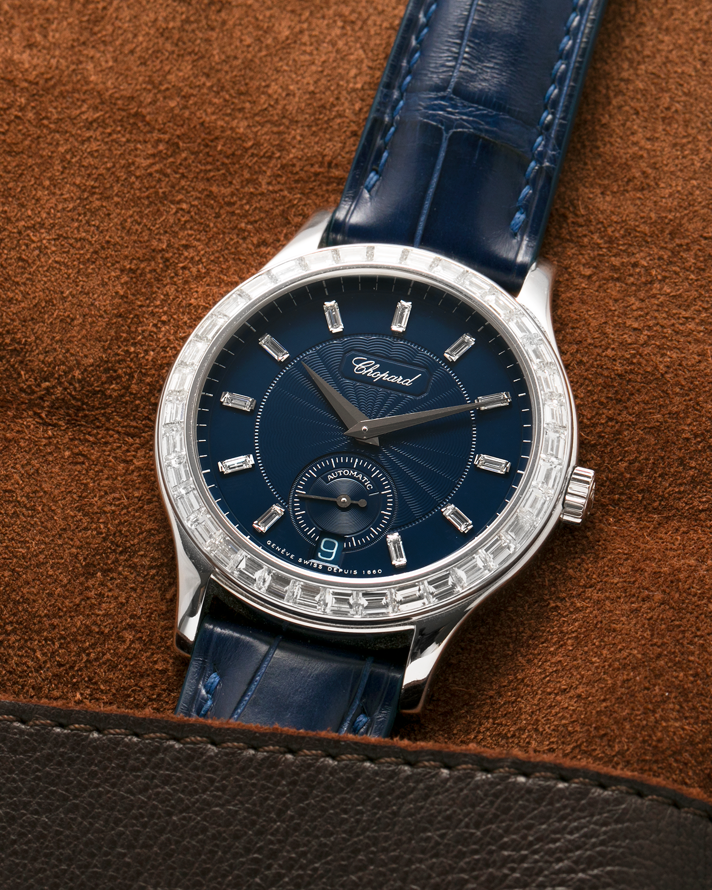 Brand: Chopard L.U.C.
Year: 2000’s
Model: 16/1864/2 Based Off 16/1860/2
Material: 18-carat White Gold Case, Factory-Set Baguette Diamond Bezel and Dial
Movement: Chopard Cal. 1.96, Self-Winding Micro-Rotor
Case Dimensions: 37mm Diameter 8.5mm Thickness
Lug Width: 18mm
Strap: Custom Order Blue Alligator Leather Strap with 18k White Gold Chopard Tang Buckle