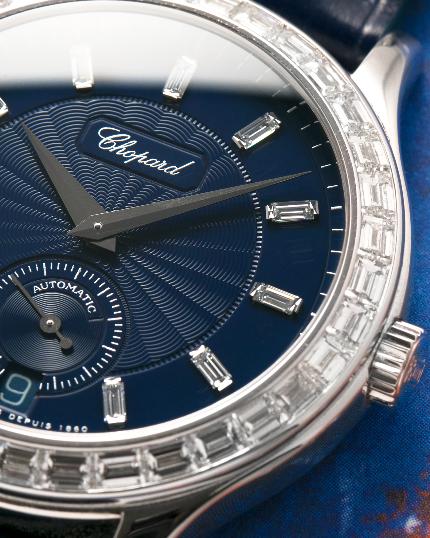 Brand: Chopard L.U.C.
Year: 2000’s
Model: 16/1864/2 Based Off 16/1860/2
Material: 18-carat White Gold Case, Factory-Set Baguette Diamond Bezel and Dial
Movement: Chopard Cal. 1.96, Self-Winding Micro-Rotor
Case Dimensions: 37mm Diameter 8.5mm Thickness
Lug Width: 18mm
Strap: Custom Order Blue Alligator Leather Strap with 18k White Gold Chopard Tang Buckle