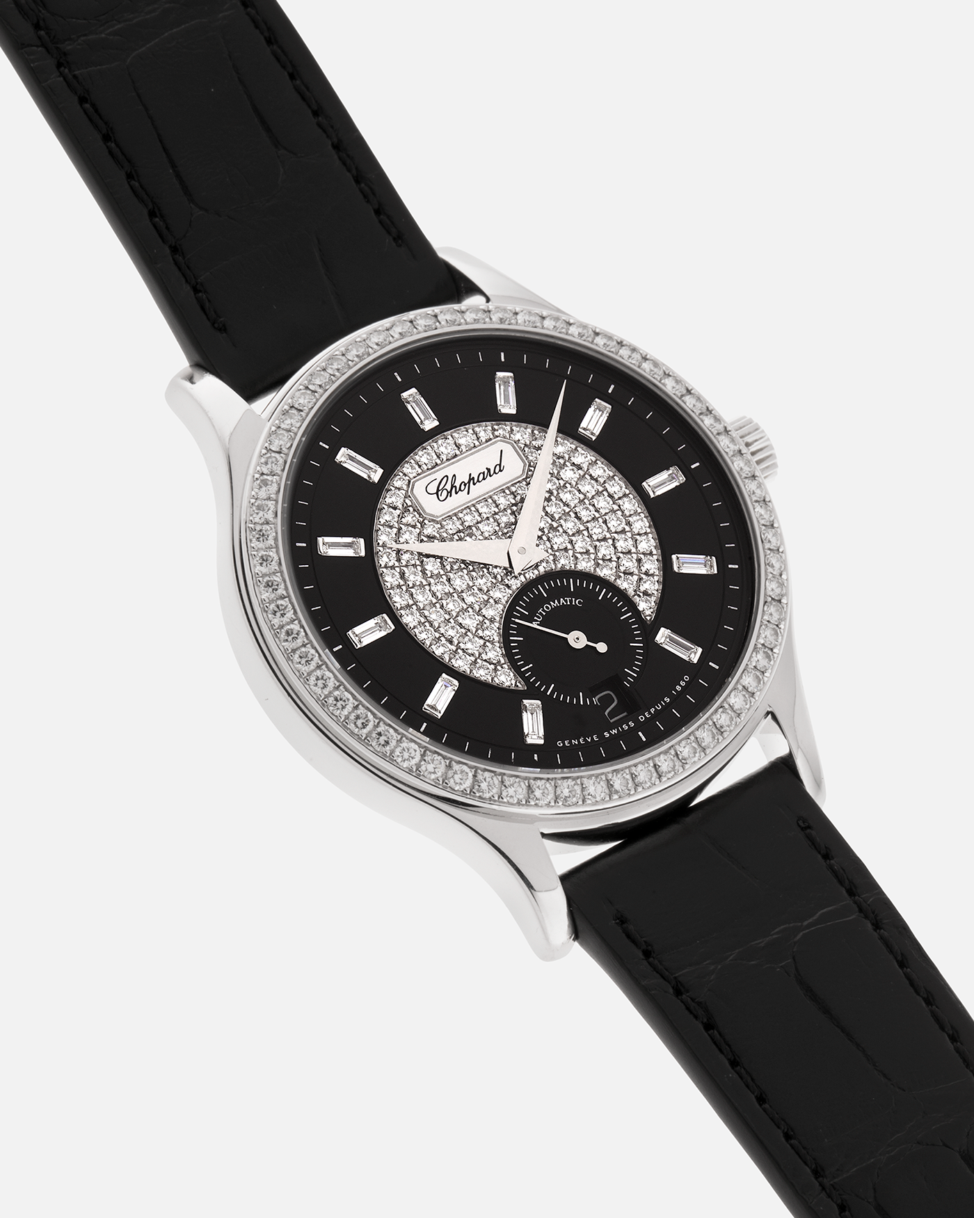 Brand: Chopard L.U.C.
Year: 2000’s
Model: 17/1873/2 Based Off 16/1860/2
Material: 18-carat White Gold Case, Factory-Set Diamond Bezel and Dial
Movement: Chopard Cal. 1.96, Self-Winding Micro-Rotor
Case Dimensions: 37mm Diameter 8.5mm Thickness
Lug Width: 18mm
Strap: Chopard Black Alligator Strap with 18k White Gold Chopard Tang Buckle