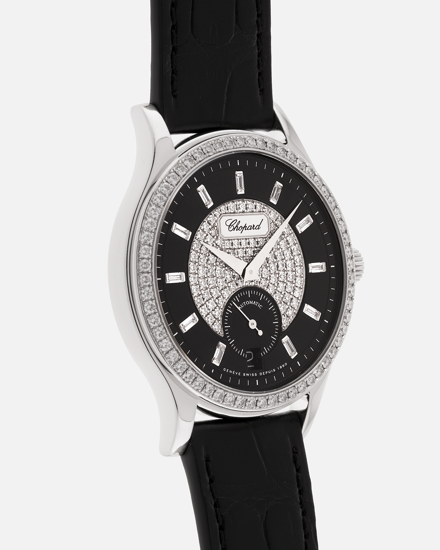 Brand: Chopard L.U.C.
Year: 2000’s
Model: 17/1873/2 Based Off 16/1860/2
Material: 18-carat White Gold Case, Factory-Set Diamond Bezel and Dial
Movement: Chopard Cal. 1.96, Self-Winding Micro-Rotor
Case Dimensions: 37mm Diameter 8.5mm Thickness
Lug Width: 18mm
Strap: Chopard Black Alligator Strap with 18k White Gold Chopard Tang Buckle