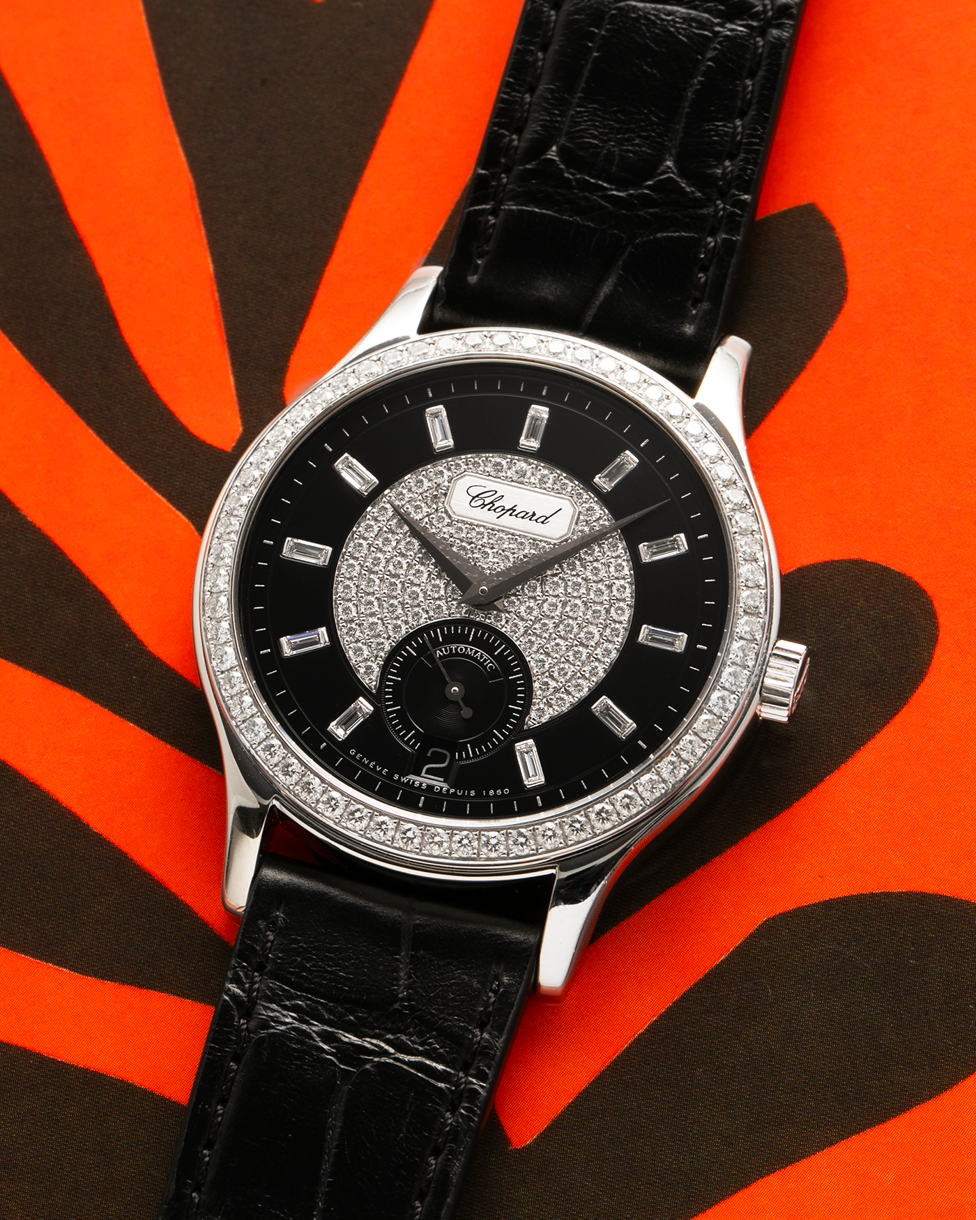 Brand: Chopard L.U.C.
Year: 2000’s
Model: 17/1873/2 Based Off 16/1860/2
Material: 18-carat White Gold Case, Factory-Set Diamond Bezel and Dial
Movement: Chopard Cal. 1.96, Self-Winding Micro-Rotor
Case Dimensions: 37mm Diameter 8.5mm Thickness
Lug Width: 18mm
Strap: Chopard Black Alligator Strap with 18k White Gold Chopard Tang Buckle