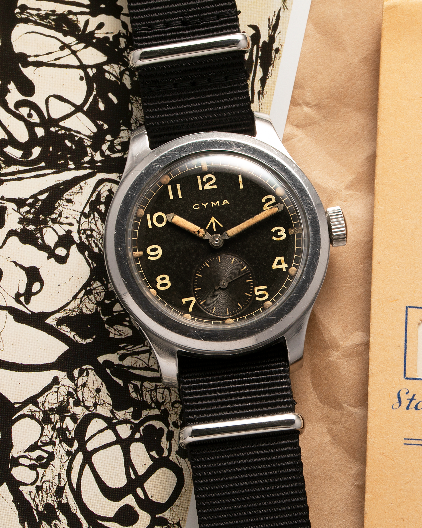 Brand: Cyma Year: 1940s Model: W.W.W. (Watch, Wristlet, Waterproof) Material: Stainless Steel Movement: Cyma Cal. 234, Manual-Winding Case Diameter: 38mm Lug Width: 18mm Strap: Generic Black Fabric NATO strap