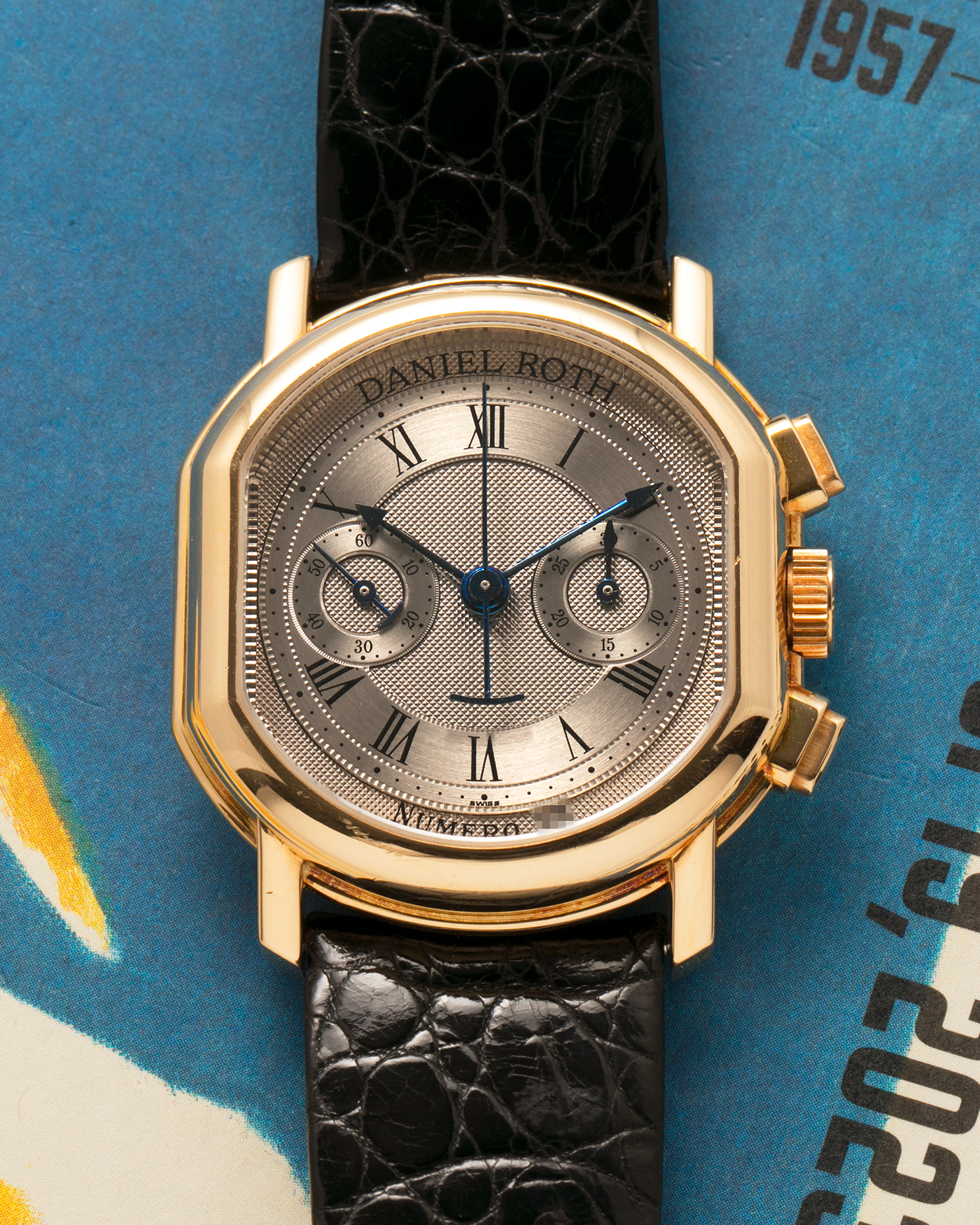 Brand: Daniel Roth
Year: Early 1990s
Model: 2147 Chronograph
Material: 18-carat Yellow Gold
Movement: Lemania Cal. 2320, Manual-Winding
Case Diameter: 35mm x 38mm (10mm Thickness)
Lug Width: 20mm
Strap: Daniel Roth Black Alligator Strap and 18k Yellow Gold Daniel Roth Tang Buckle