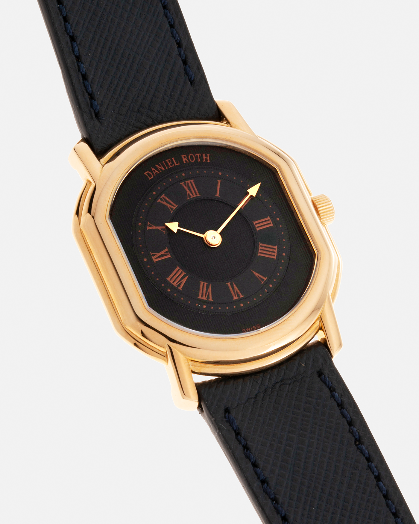 Brand: Daniel Roth Year: Early 1990s Model: Midi Plat Black Dial Reference Number: 2167 Material: 18-carat Yellow Gold  Movement: Daniel Roth Cal. 196, Manual-Winding Case Diameter: 37mm x 32mm Lug Width: 18mm Strap: Molequin Navy Textured Calf Leather Strap with Signed 18-carat Yellow Gold Tang Buckle