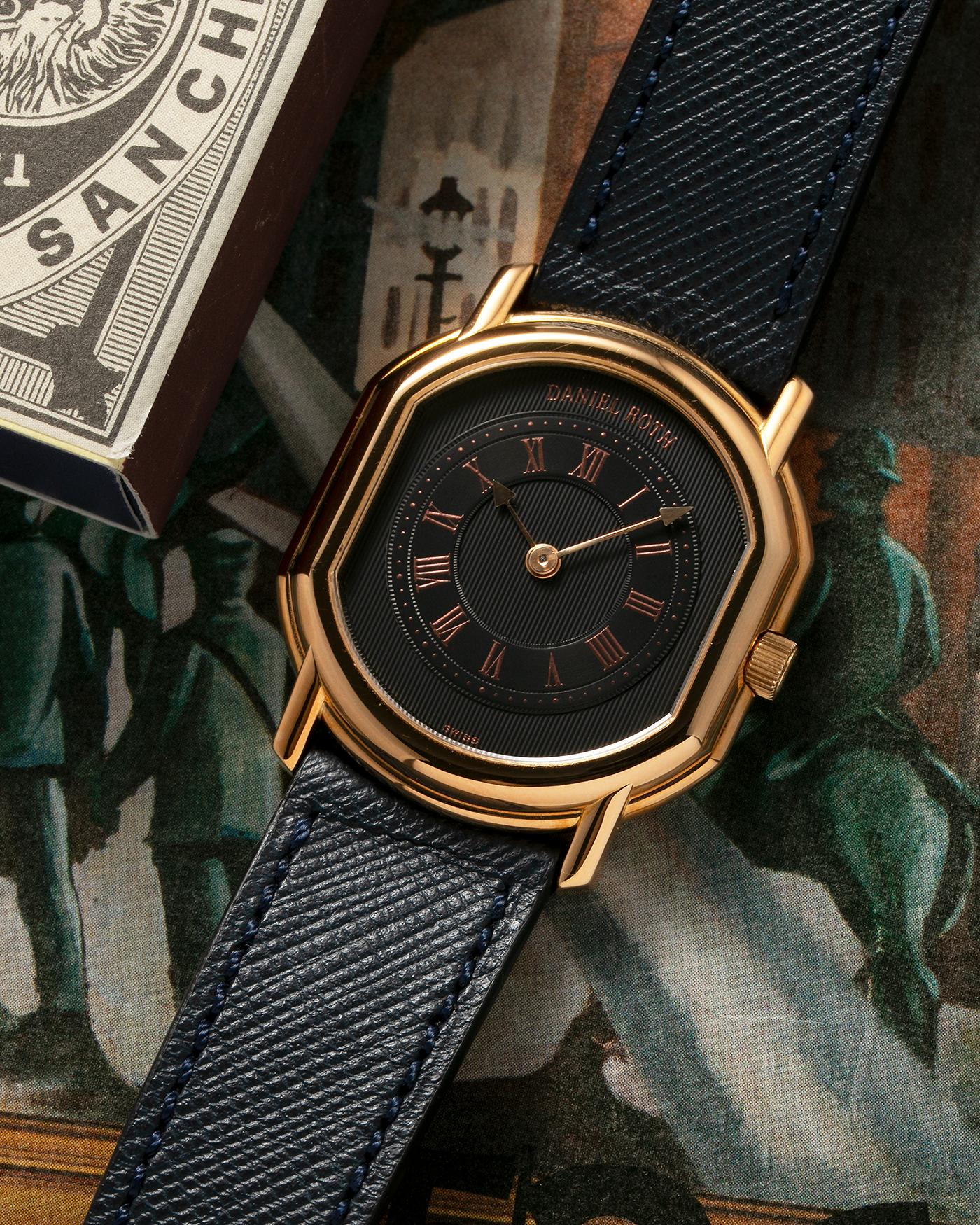 Brand: Daniel Roth Year: Early 1990s Model: Midi Plat Black Dial Reference Number: 2167 Material: 18-carat Yellow Gold  Movement: Daniel Roth Cal. 196, Manual-Winding Case Diameter: 37mm x 32mm Lug Width: 18mm Strap: Molequin Navy Textured Calf Leather Strap with Signed 18-carat Yellow Gold Tang Buckle