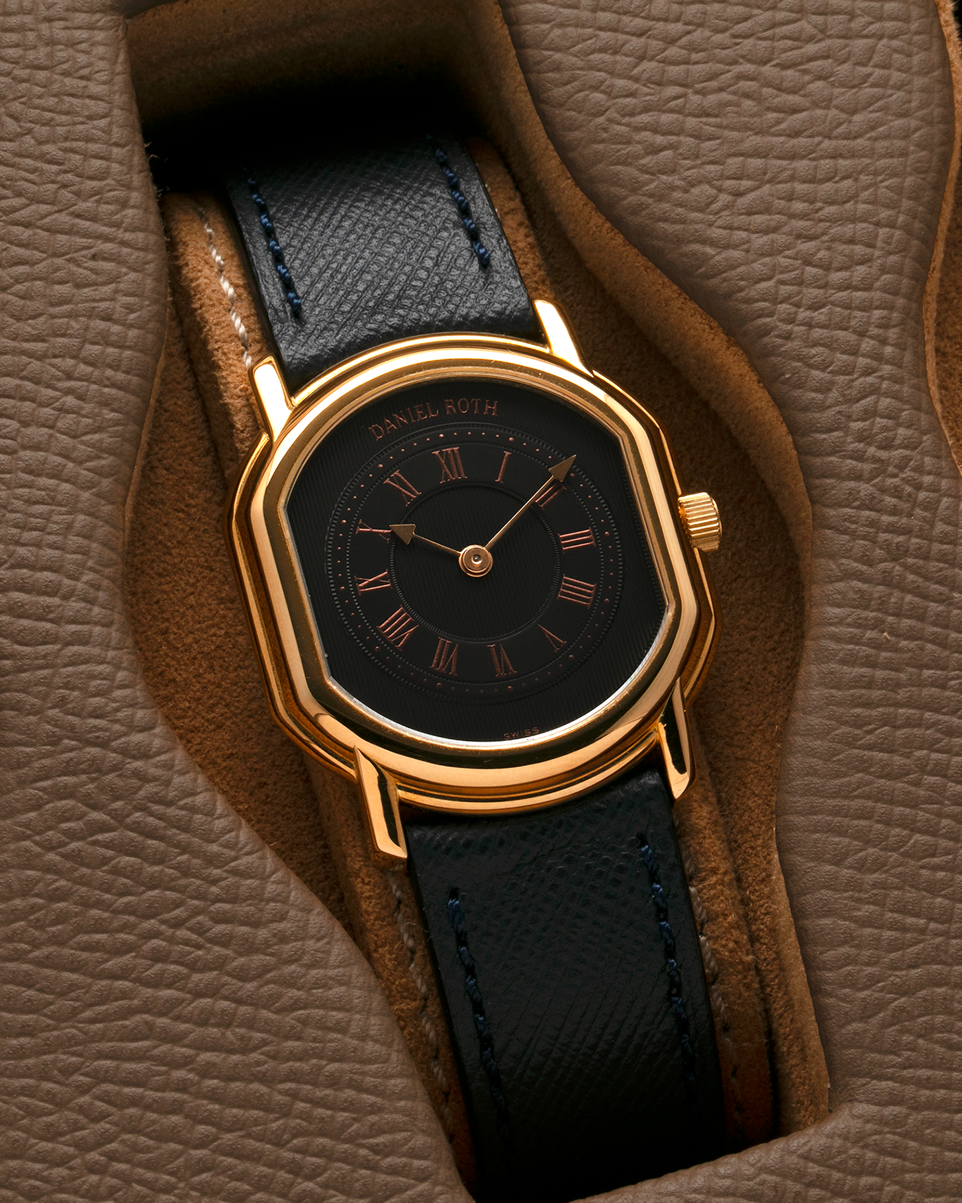 Brand: Daniel Roth Year: Early 1990s Model: Midi Plat Black Dial Reference Number: 2167 Material: 18-carat Yellow Gold  Movement: Daniel Roth Cal. 196, Manual-Winding Case Diameter: 37mm x 32mm Lug Width: 18mm Strap: Molequin Navy Textured Calf Leather Strap with Signed 18-carat Yellow Gold Tang Buckle
