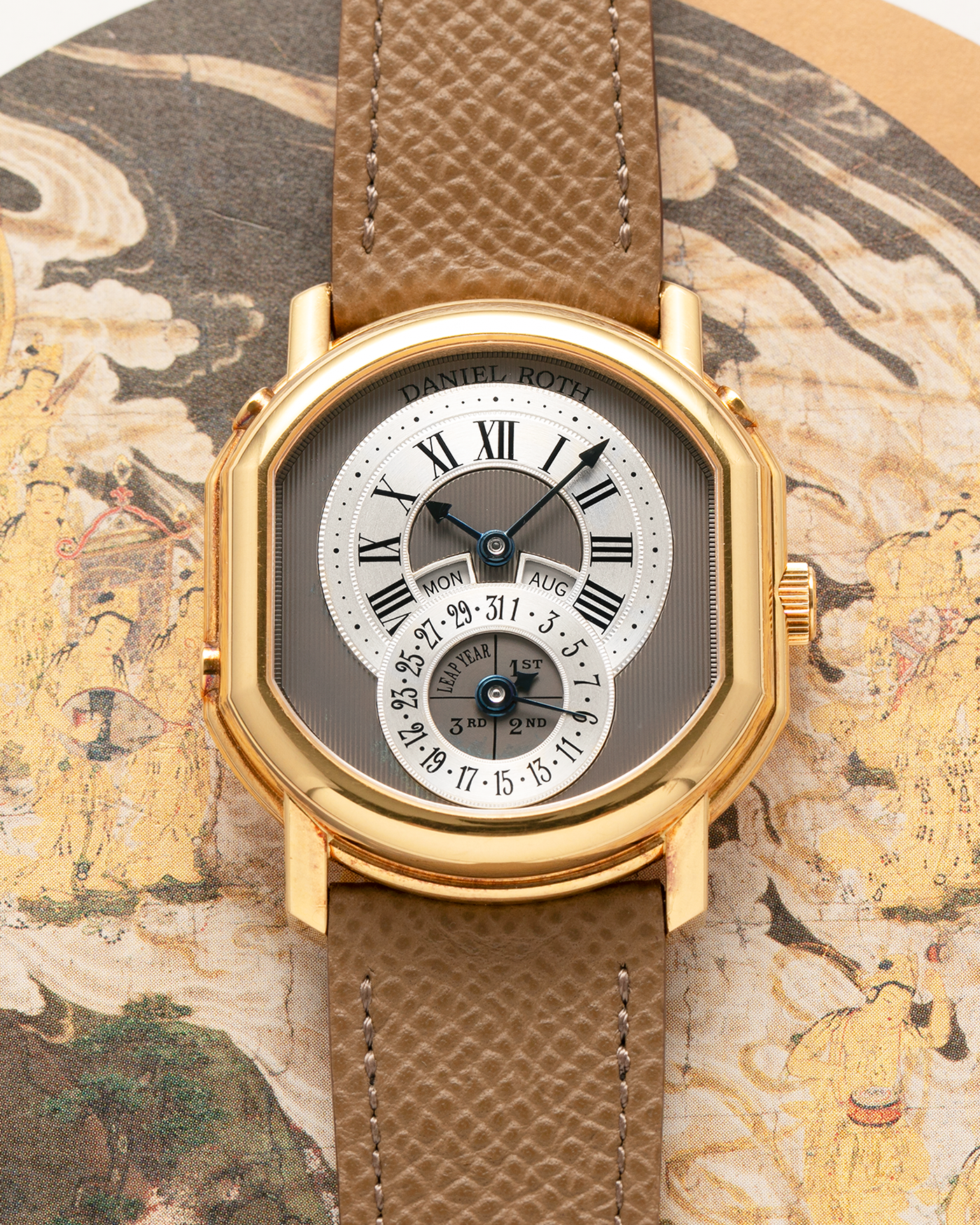 Brand: Daniel Roth
Year: Early 1990’s
Model: 2117 Perpetual Calendar (First Generation)
Material: 18-carat Yellow Gold
Movement: Daniel Roth Cal. DR117 (Based on Lemania Cal. 8810), Self-Winding
Case Dimensions: 35mm x 38mm (Lug-to-Lug 41mm)
Lug Width: 20mm
Strap: Nostime Taupe Brown Textured Calf Leather Strap with Signed 18-carat Yellow Gold Tang Buckle