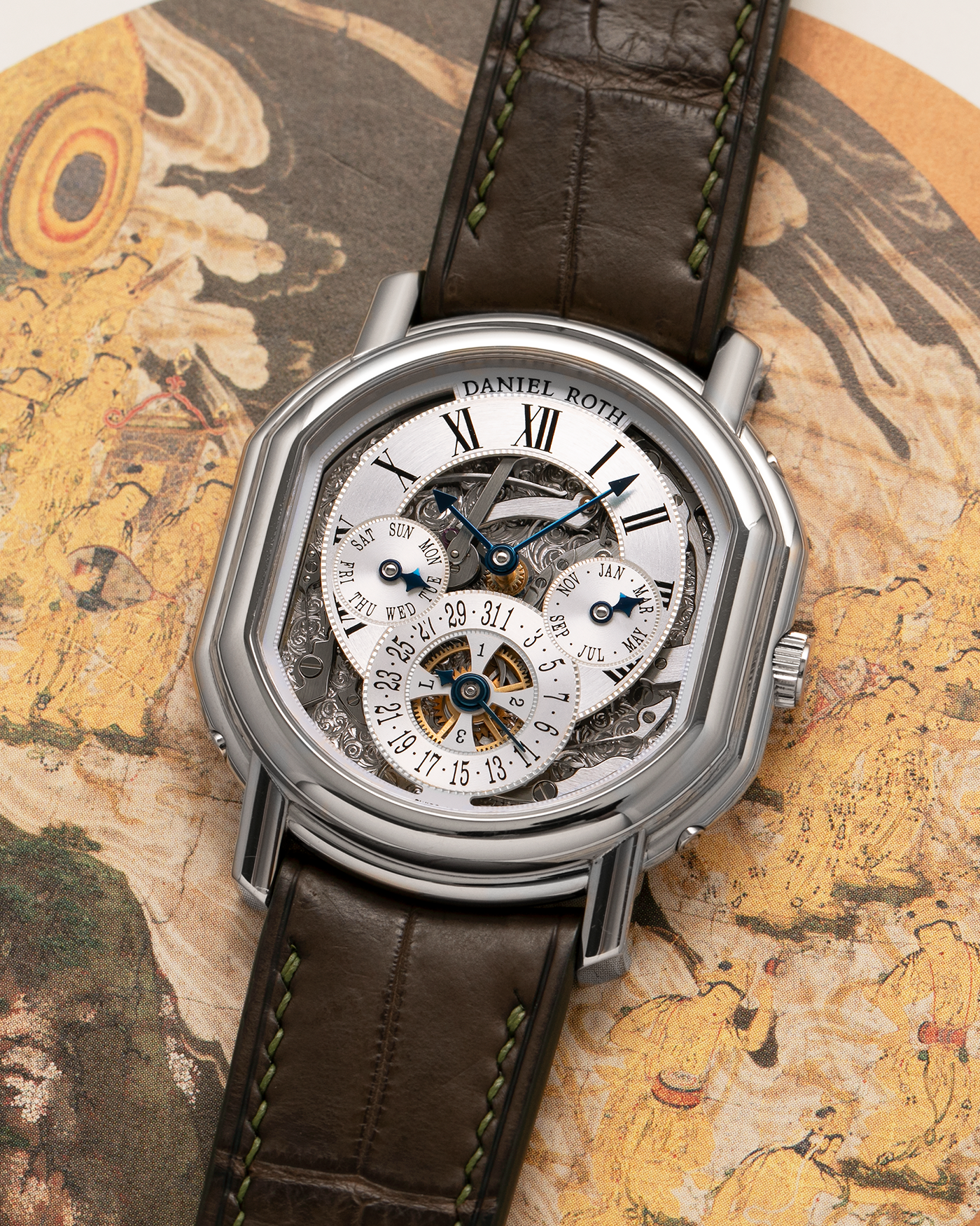Brand: Daniel Roth
Year: 1990’s
Model: Perpetual Calendar Skeleton
Reference: 119.X.60
Material: 18-carat White Gold
Movement: Daniel Roth Cal. DR114 (Based on Girard-Perregaux GP3000), Self-Winding
Case Dimensions: 41mm (Including Lugs) x 38mm x 9.8mm
Lug Width: 20mm
Straps: Custom Dark Brown Alligator Leather Strap with Signed 18-carat White Gold Tang Buckle, with extra Daniel Roth Black Alligator Leather Strap