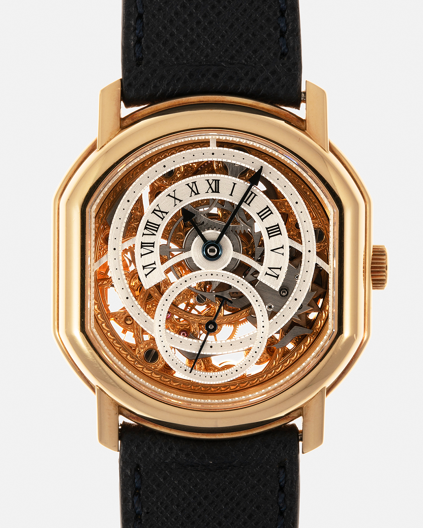 Brand: Daniel Roth
Year: 1990’s
Model: 2127 Retrograde Skeleton
Material: 18-carat Yellow Gold
Movement: Lemania Cal. 27LN with Retrograde Function, Manual-Winding
Case Diameter: 35mm x 38mm (41mm Lug-to-Lug)
Lug Width: 20mm
Strap: Molequin Navy Blue Grained Calf Strap with Signed 18-carat Yellow Gold Tang Buckle