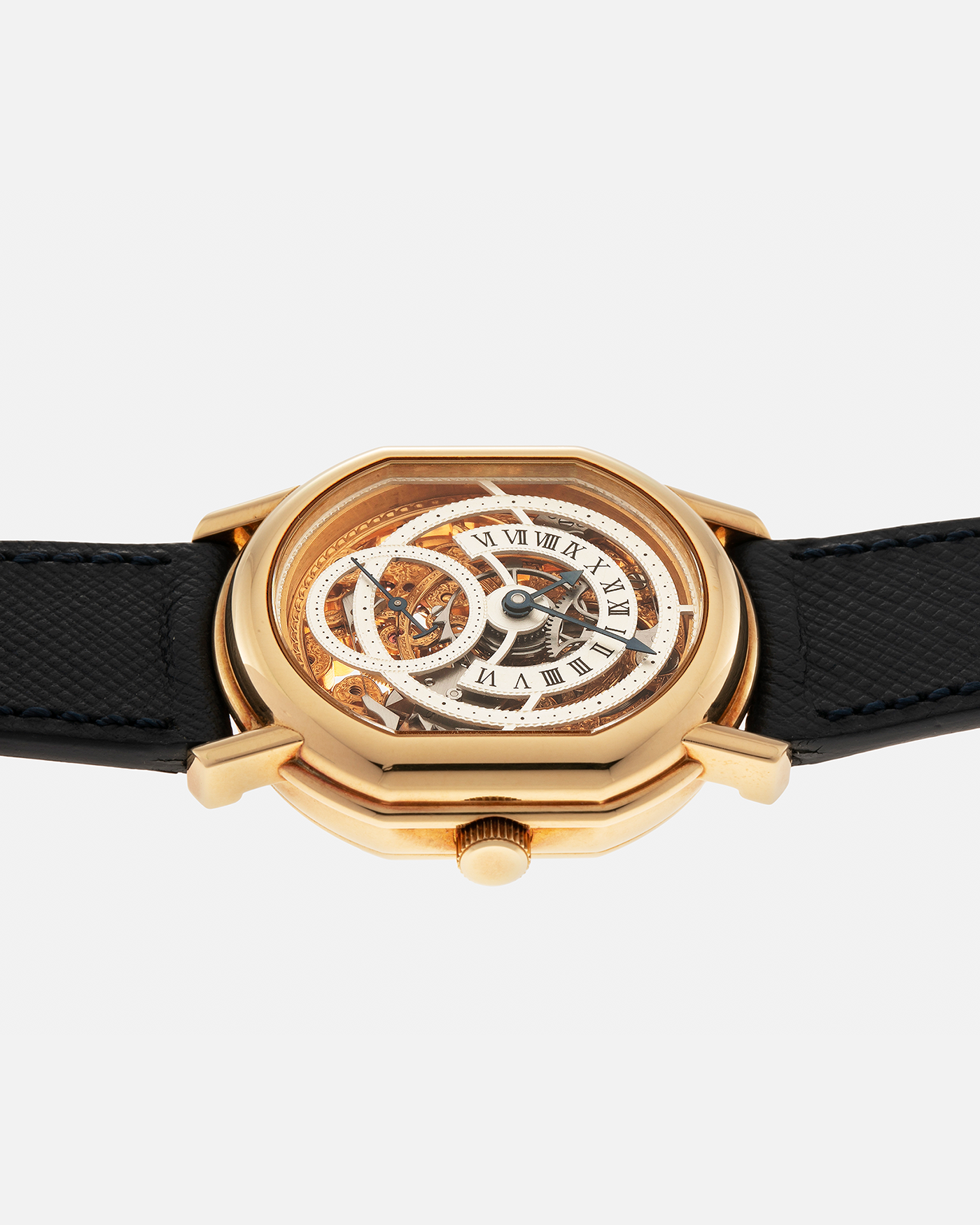 Brand: Daniel Roth
Year: 1990’s
Model: 2127 Retrograde Skeleton
Material: 18-carat Yellow Gold
Movement: Lemania Cal. 27LN with Retrograde Function, Manual-Winding
Case Diameter: 35mm x 38mm (41mm Lug-to-Lug)
Lug Width: 20mm
Strap: Molequin Navy Blue Grained Calf Strap with Signed 18-carat Yellow Gold Tang Buckle