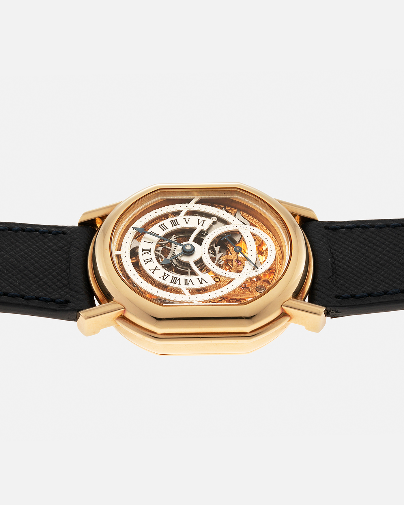 Brand: Daniel Roth
Year: 1990’s
Model: 2127 Retrograde Skeleton
Material: 18-carat Yellow Gold
Movement: Lemania Cal. 27LN with Retrograde Function, Manual-Winding
Case Diameter: 35mm x 38mm (41mm Lug-to-Lug)
Lug Width: 20mm
Strap: Molequin Navy Blue Grained Calf Strap with Signed 18-carat Yellow Gold Tang Buckle