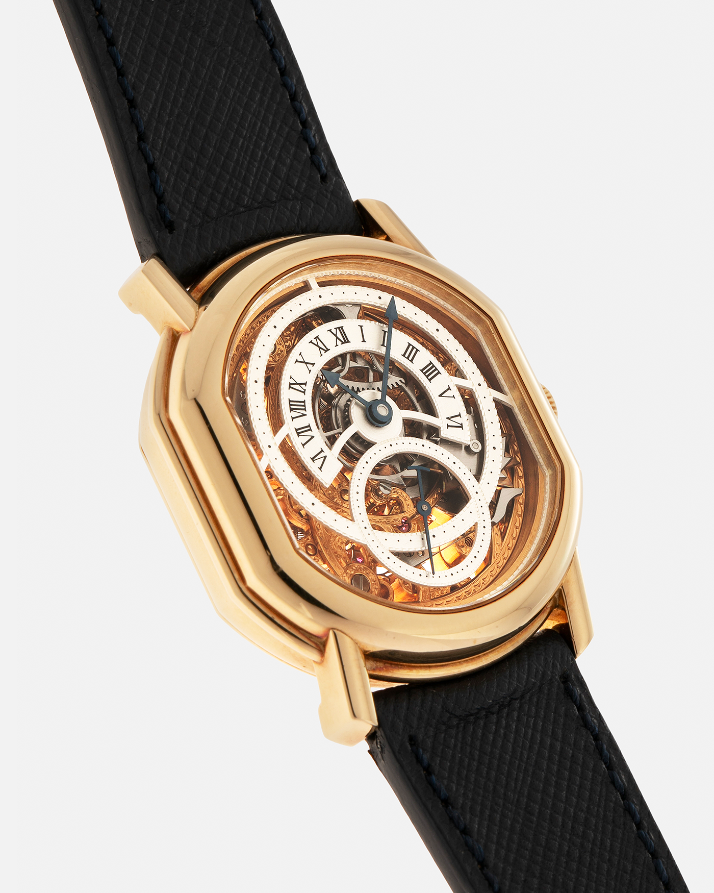 Brand: Daniel Roth
Year: 1990’s
Model: 2127 Retrograde Skeleton
Material: 18-carat Yellow Gold
Movement: Lemania Cal. 27LN with Retrograde Function, Manual-Winding
Case Diameter: 35mm x 38mm (41mm Lug-to-Lug)
Lug Width: 20mm
Strap: Molequin Navy Blue Grained Calf Strap with Signed 18-carat Yellow Gold Tang Buckle