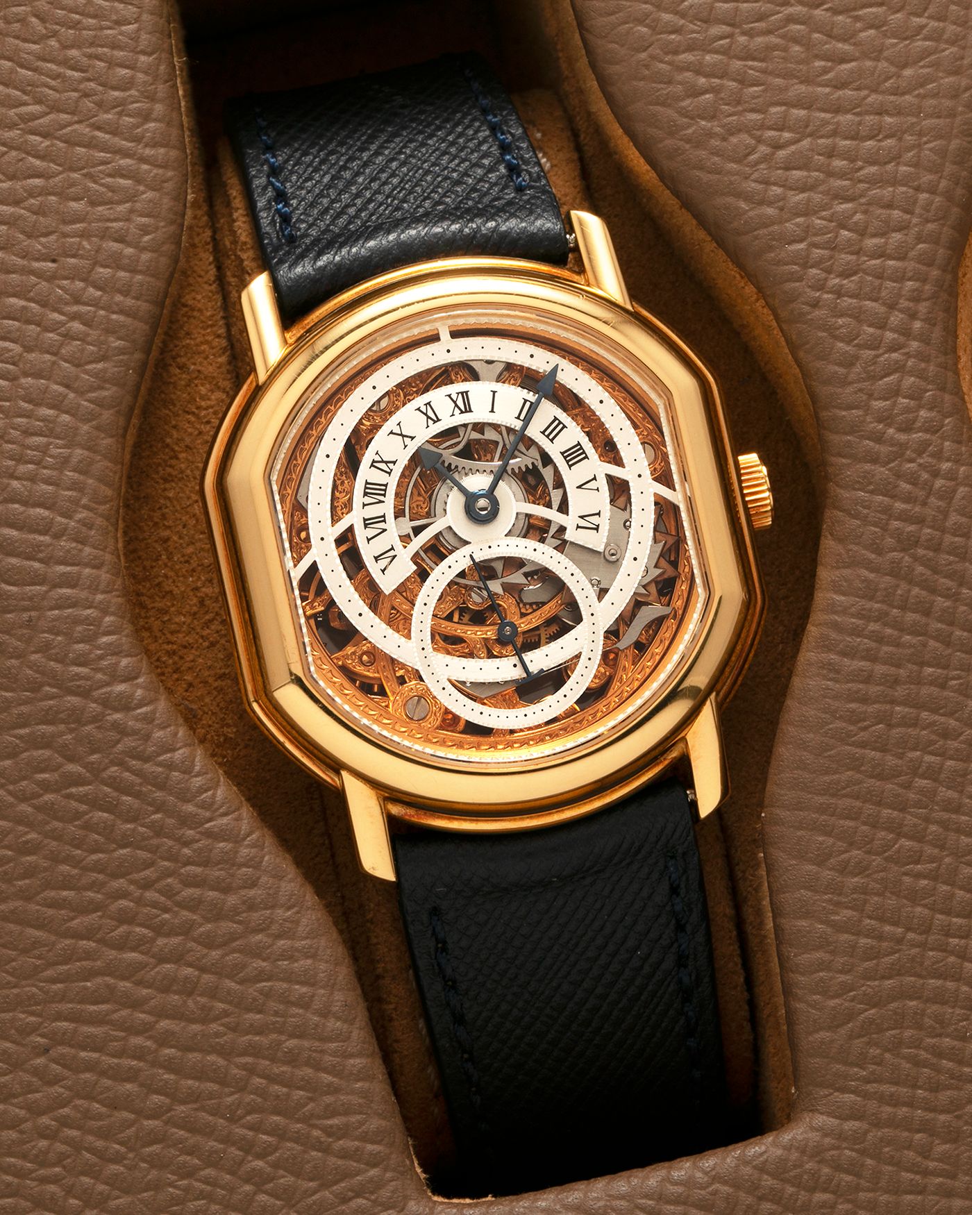Brand: Daniel Roth
Year: 1990’s
Model: 2127 Retrograde Skeleton
Material: 18-carat Yellow Gold
Movement: Lemania Cal. 27LN with Retrograde Function, Manual-Winding
Case Diameter: 35mm x 38mm (41mm Lug-to-Lug)
Lug Width: 20mm
Strap: Molequin Navy Blue Grained Calf Strap with Signed 18-carat Yellow Gold Tang Buckle