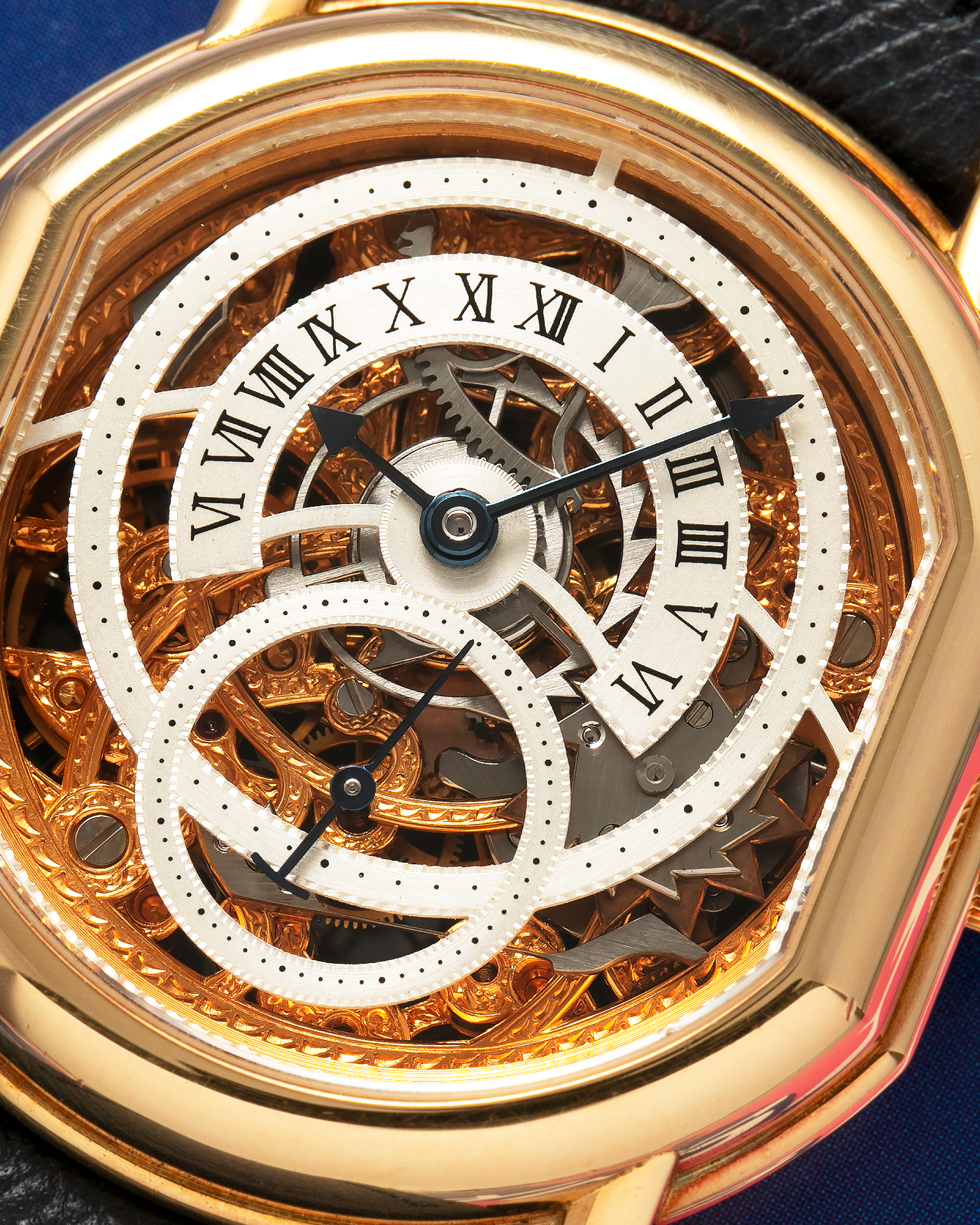 Brand: Daniel Roth
Year: 1990’s
Model: 2127 Retrograde Skeleton
Material: 18-carat Yellow Gold
Movement: Lemania Cal. 27LN with Retrograde Function, Manual-Winding
Case Diameter: 35mm x 38mm (41mm Lug-to-Lug)
Lug Width: 20mm
Strap: Molequin Navy Blue Grained Calf Strap with Signed 18-carat Yellow Gold Tang Buckle