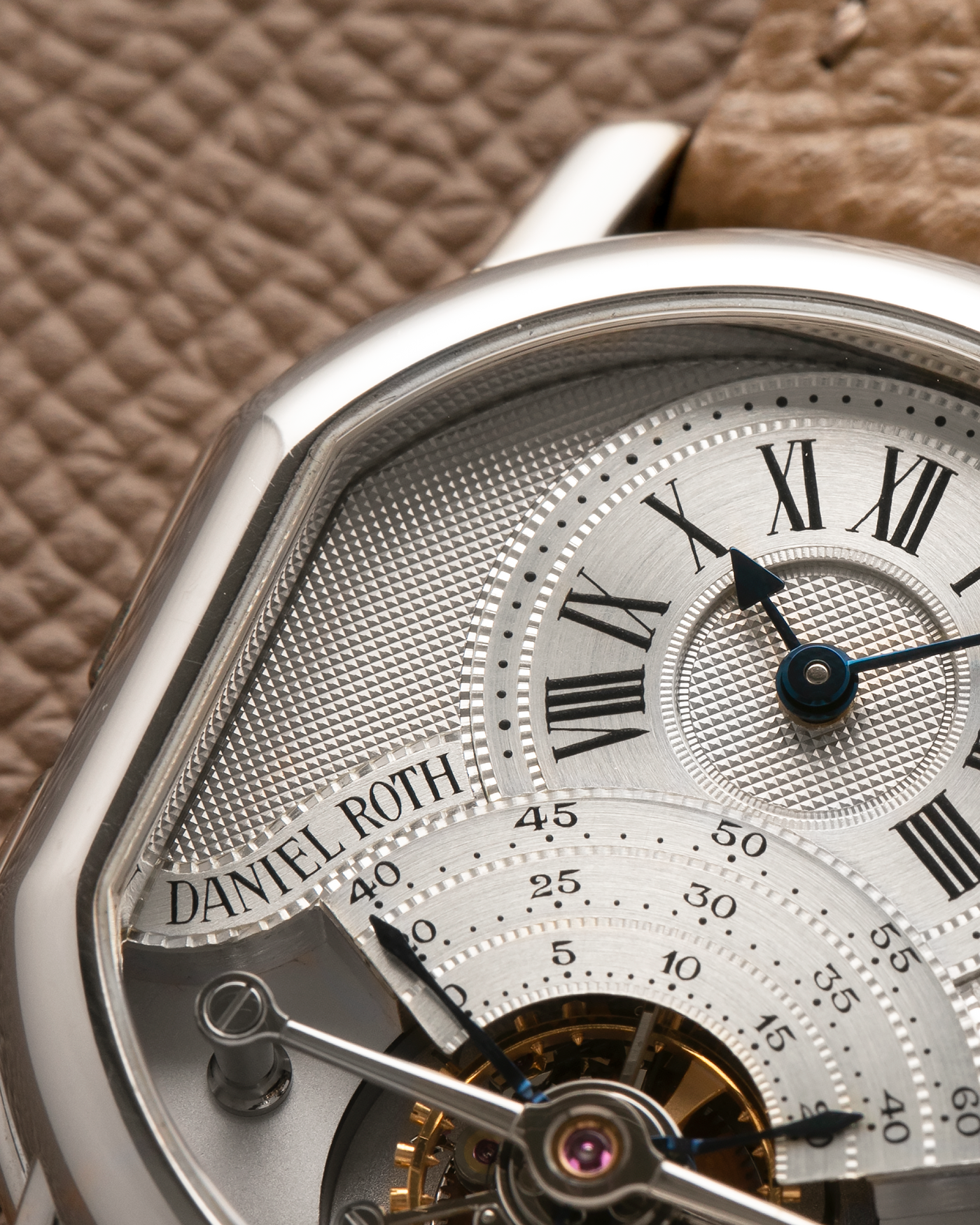 Brand: Daniel Roth
Year: Early 1990’s
Model: 2187 Régulateur Tourbillon Clou De Paris Guilloché (First Generation)
Material: 18-carat White Gold
Movement: Daniel Roth Cal. DR 307 One-Minute Tourbillon (Based on Lemania Cal. 387 Ébauche), Manual-Winding
Case Dimensions: 35mm x 38mm (Lug-to-Lug 41mm)
Lug Width: 20mm
Strap: Nostime Taupe Brown Textured Calf Leather Strap