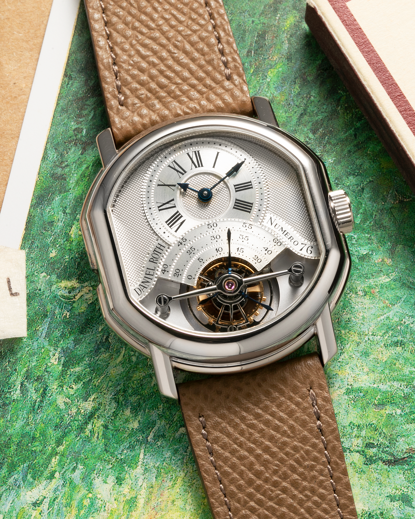 Brand: Daniel Roth
Year: Early 1990’s
Model: 2187 Régulateur Tourbillon Clou De Paris Guilloché (First Generation)
Material: 18-carat White Gold
Movement: Daniel Roth Cal. DR 307 One-Minute Tourbillon (Based on Lemania Cal. 387 Ébauche), Manual-Winding
Case Dimensions: 35mm x 38mm (Lug-to-Lug 41mm)
Lug Width: 20mm
Strap: Nostime Taupe Brown Textured Calf Leather Strap