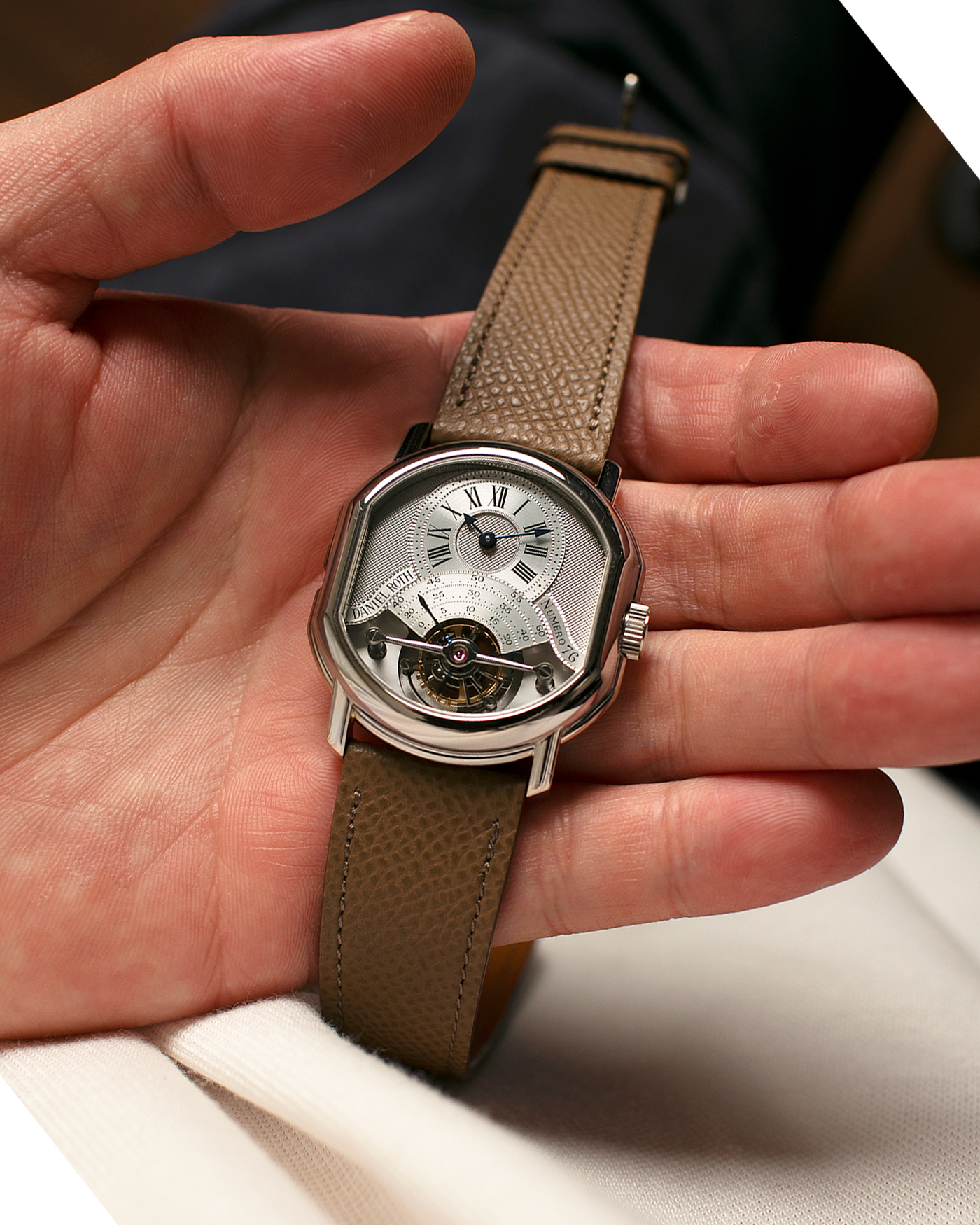 Brand: Daniel Roth
Year: Early 1990’s
Model: 2187 Régulateur Tourbillon Clou De Paris Guilloché (First Generation)
Material: 18-carat White Gold
Movement: Daniel Roth Cal. DR 307 One-Minute Tourbillon (Based on Lemania Cal. 387 Ébauche), Manual-Winding
Case Dimensions: 35mm x 38mm (Lug-to-Lug 41mm)
Lug Width: 20mm
Strap: Nostime Taupe Brown Textured Calf Leather Strap