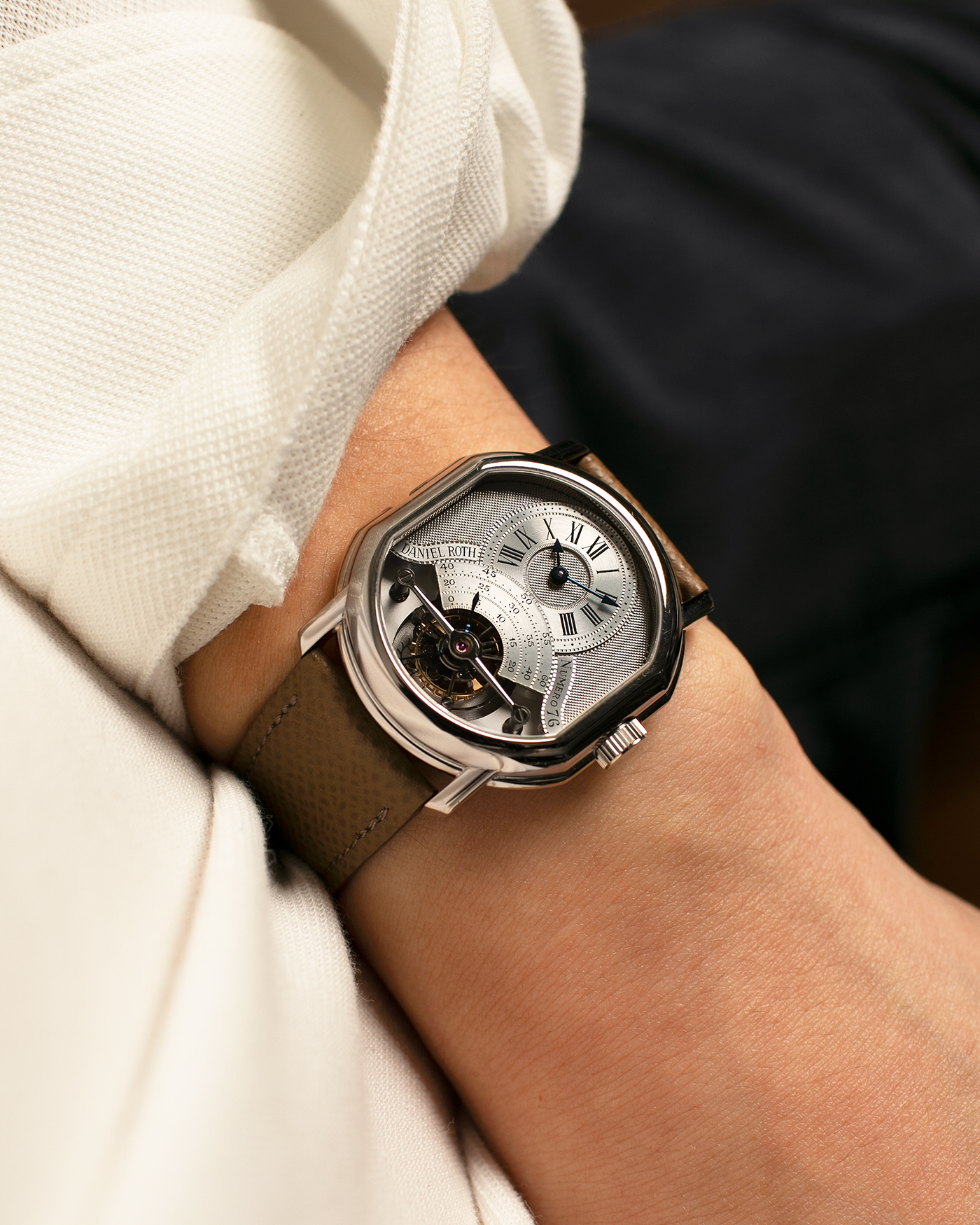 Brand: Daniel Roth
Year: Early 1990’s
Model: 2187 Régulateur Tourbillon Clou De Paris Guilloché (First Generation)
Material: 18-carat White Gold
Movement: Daniel Roth Cal. DR 307 One-Minute Tourbillon (Based on Lemania Cal. 387 Ébauche), Manual-Winding
Case Dimensions: 35mm x 38mm (Lug-to-Lug 41mm)
Lug Width: 20mm
Strap: Nostime Taupe Brown Textured Calf Leather Strap