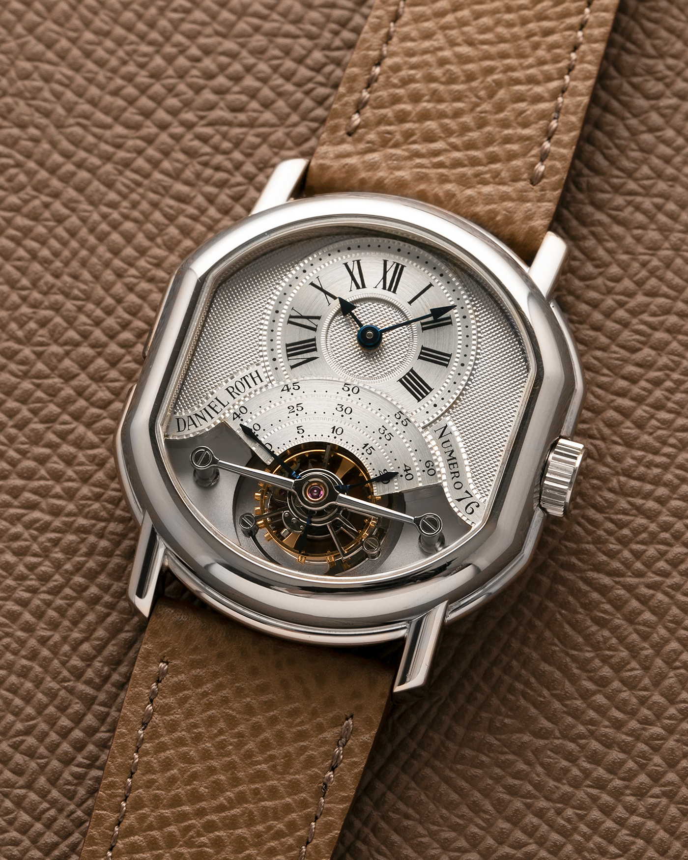 Brand: Daniel Roth
Year: Early 1990’s
Model: 2187 Régulateur Tourbillon Clou De Paris Guilloché (First Generation)
Material: 18-carat White Gold
Movement: Daniel Roth Cal. DR 307 One-Minute Tourbillon (Based on Lemania Cal. 387 Ébauche), Manual-Winding
Case Dimensions: 35mm x 38mm (Lug-to-Lug 41mm)
Lug Width: 20mm
Strap: Nostime Taupe Brown Textured Calf Leather Strap