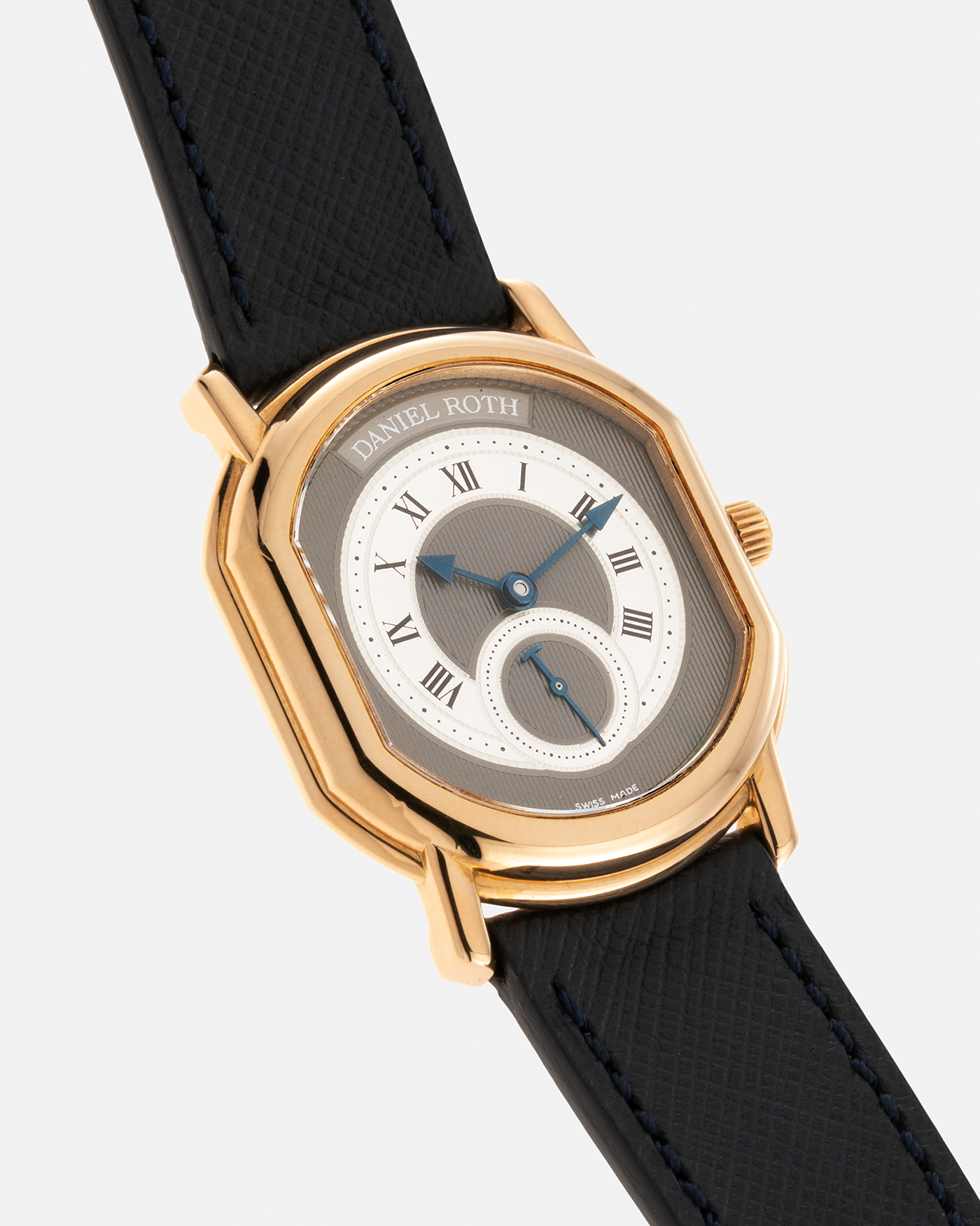 Brand: Daniel Roth Year: 1990’s Model: Seconds at Six, Mid-Size Material: 18-carat Yellow Gold  Movement: Lemania Cal. 1918, Self-Winding Case Dimensions: 35mm x 32mm Lug Width: 18mm Strap: Molequin Navy Textured Calf Leather Strap with Generic Stainless Steel Tang Buckle