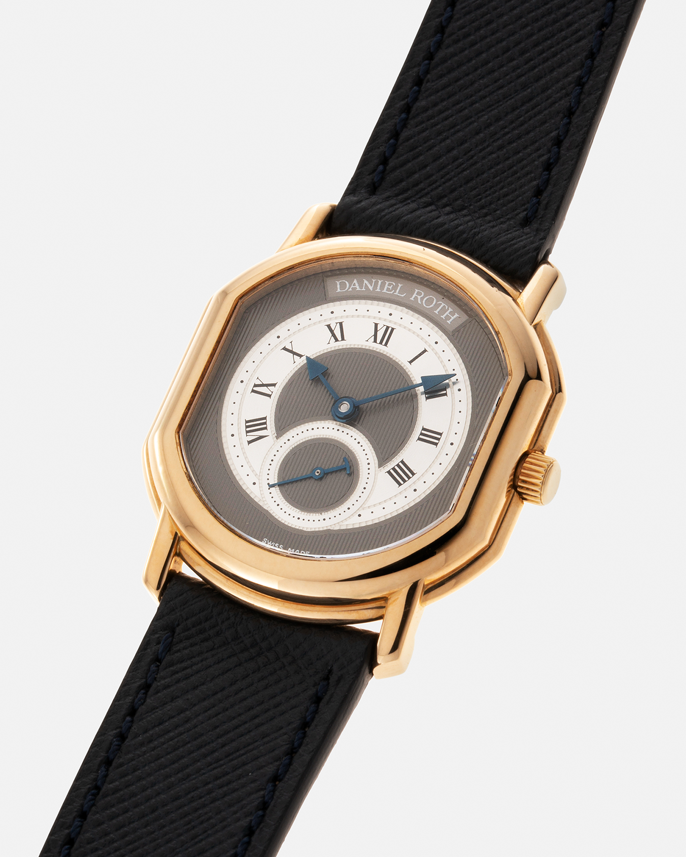 Brand: Daniel Roth Year: 1990’s Model: Seconds at Six, Mid-Size Material: 18-carat Yellow Gold  Movement: Lemania Cal. 1918, Self-Winding Case Dimensions: 35mm x 32mm Lug Width: 18mm Strap: Molequin Navy Textured Calf Leather Strap with Generic Stainless Steel Tang Buckle