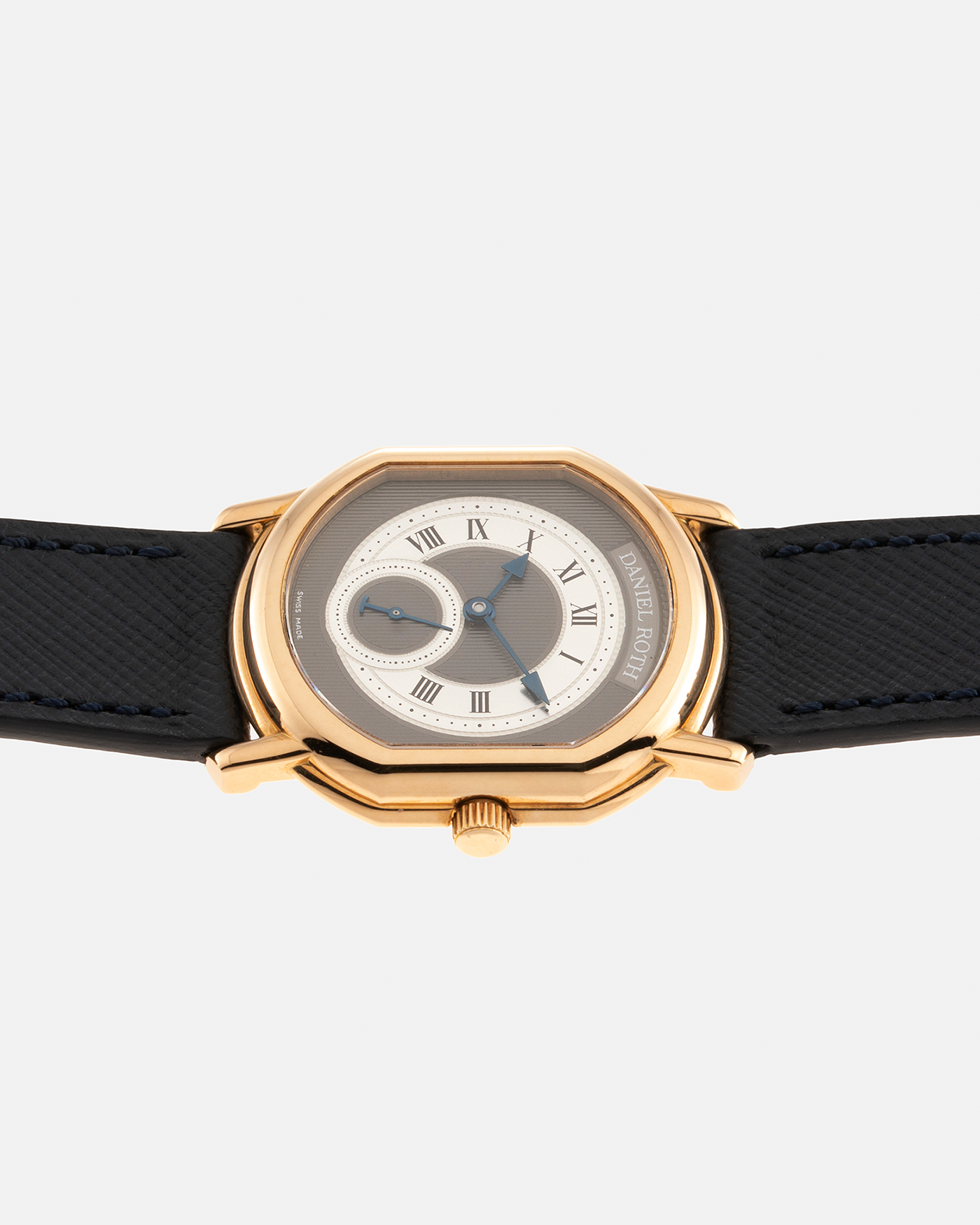 Brand: Daniel Roth Year: 1990’s Model: Seconds at Six, Mid-Size Material: 18-carat Yellow Gold  Movement: Lemania Cal. 1918, Self-Winding Case Dimensions: 35mm x 32mm Lug Width: 18mm Strap: Molequin Navy Textured Calf Leather Strap with Generic Stainless Steel Tang Buckle