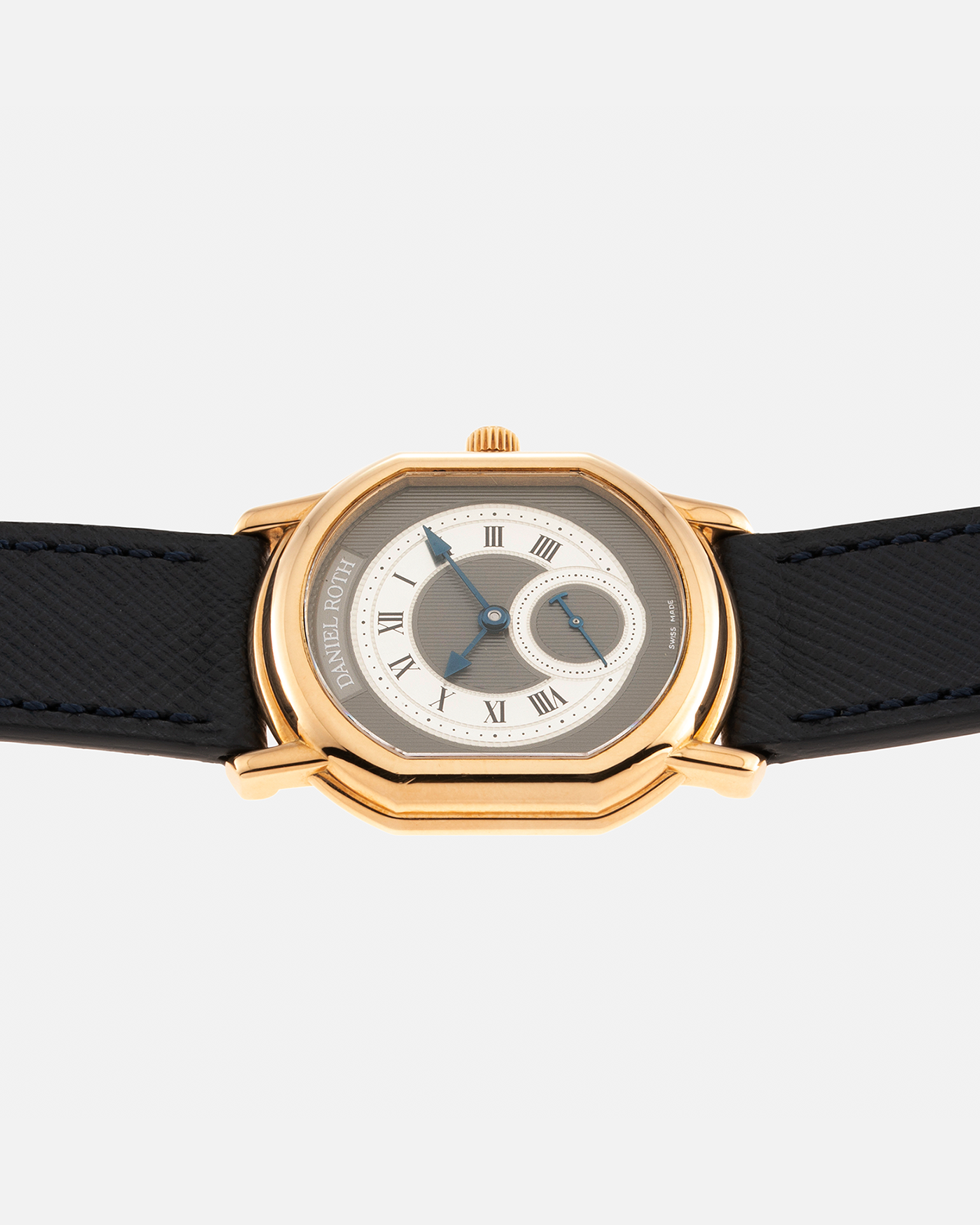 Brand: Daniel Roth Year: 1990’s Model: Seconds at Six, Mid-Size Material: 18-carat Yellow Gold  Movement: Lemania Cal. 1918, Self-Winding Case Dimensions: 35mm x 32mm Lug Width: 18mm Strap: Molequin Navy Textured Calf Leather Strap with Generic Stainless Steel Tang Buckle