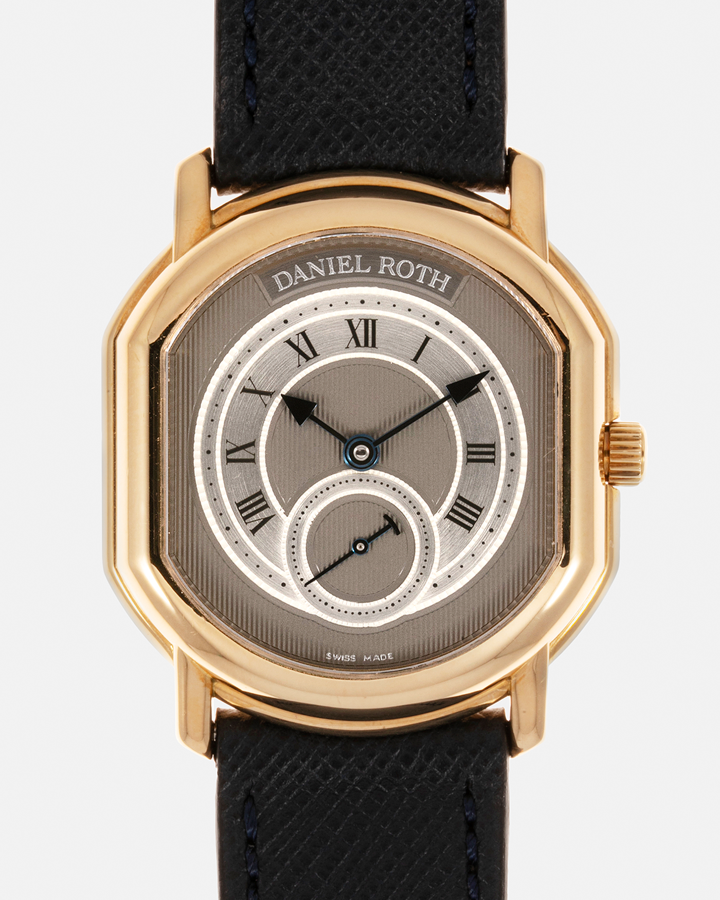 Brand: Daniel Roth Year: 1990’s Model: Seconds at Six, Mid-Size Material: 18-carat Yellow Gold  Movement: Lemania Cal. 1918, Self-Winding Case Dimensions: 35mm x 32mm Lug Width: 18mm Strap: Molequin Navy Textured Calf Leather Strap with Generic Stainless Steel Tang Buckle