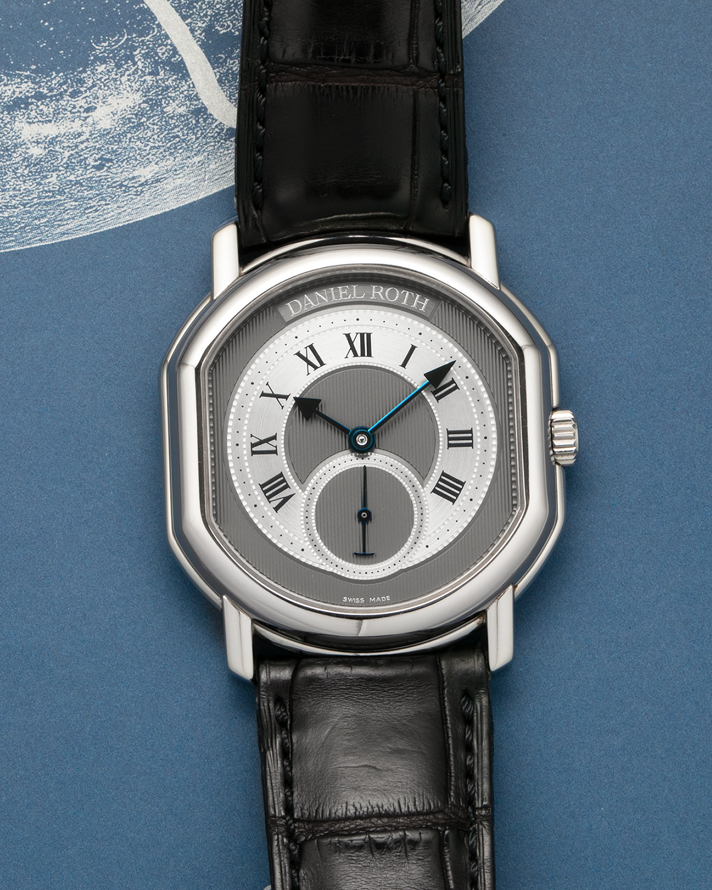 Brand: Daniel Roth
Year: 1990’s
Model: Seconds at Six
Reference: 207
Material: Stainless Steel
Movement: Daniel Roth Cal. DR111 (Girard-Perregaux based), Self-Winding
Case Dimensions: 35mm x 38mm (Lug-to-Lug 41mm)
Lug Width: 20mm
Strap: Daniel Roth Black Alligator Leather Strap with Signed Stainless Steel Deployant Clasp