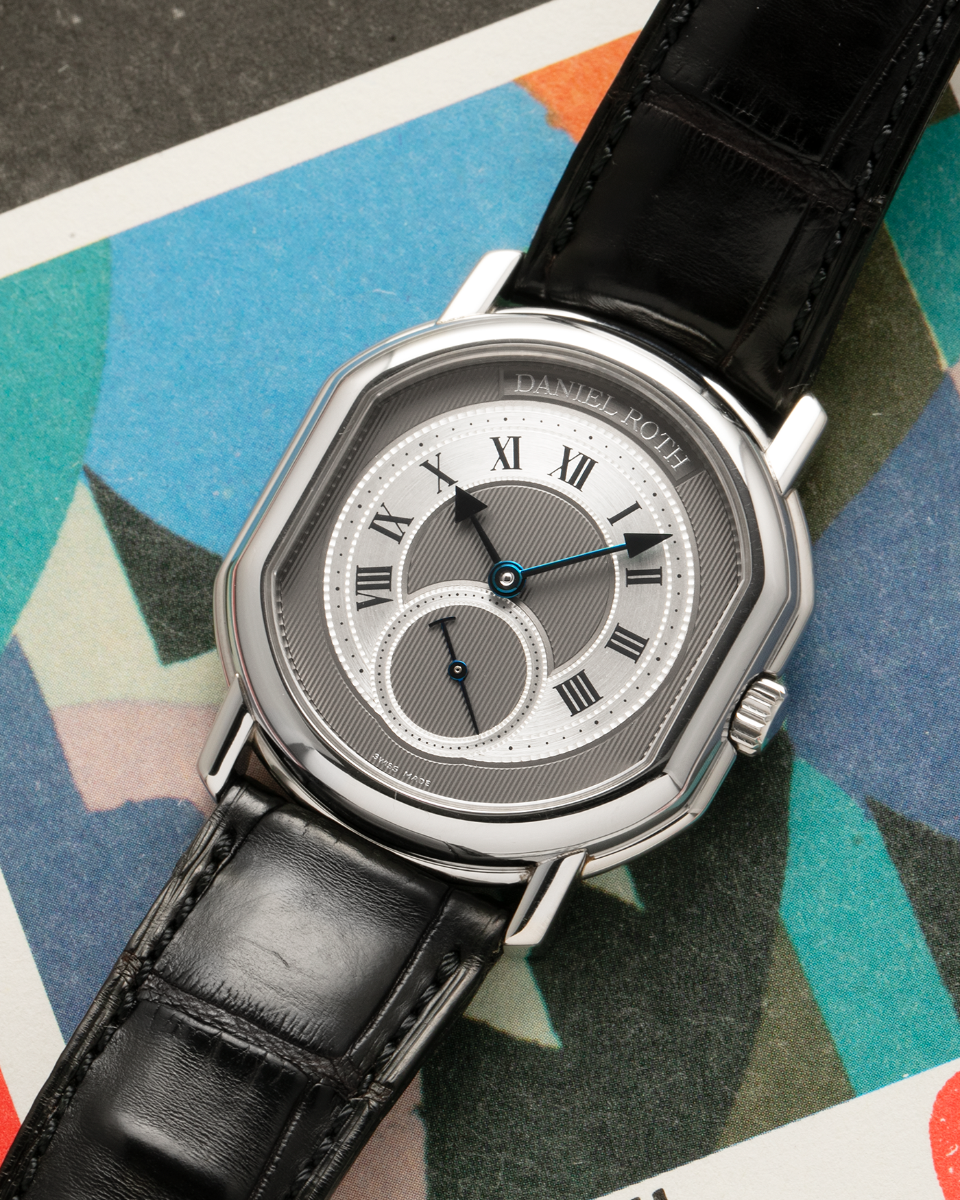 Brand: Daniel Roth
Year: 1990’s
Model: Seconds at Six
Reference: 207
Material: Stainless Steel
Movement: Daniel Roth Cal. DR111 (Girard-Perregaux based), Self-Winding
Case Dimensions: 35mm x 38mm (Lug-to-Lug 41mm)
Lug Width: 20mm
Strap: Daniel Roth Black Alligator Leather Strap with Signed Stainless Steel Deployant Clasp