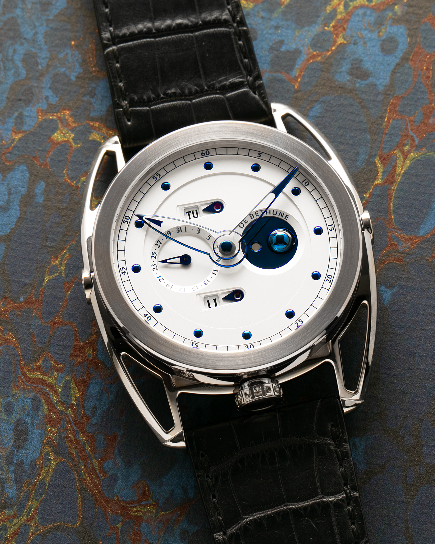 Brand: De Bethune
Year: 2008
Model: Perpetual Calendar Moonphase DB26RS1
Case Material: 18k White Gold, Titanium Lugs
Movement: Manual Winding DB205
Case Dimensions: 44.4mm Diameter 12.8mm Thickness
Strap: De Bethune Black Alligator Strap and De Bethune 18k White Gold Tang Buckle