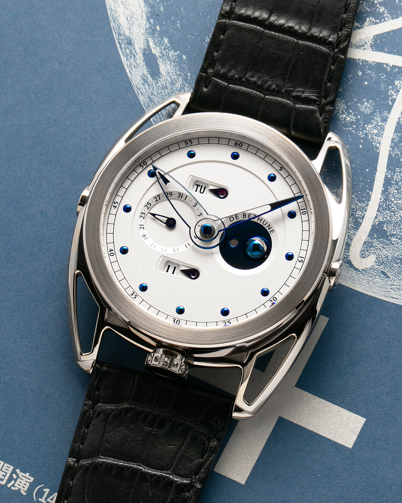 Brand: De Bethune
Year: 2008
Model: Perpetual Calendar Moonphase DB26RS1
Case Material: 18k White Gold, Titanium Lugs
Movement: Manual Winding DB205
Case Dimensions: 44.4mm Diameter 12.8mm Thickness
Strap: De Bethune Black Alligator Strap and De Bethune 18k White Gold Tang Buckle
