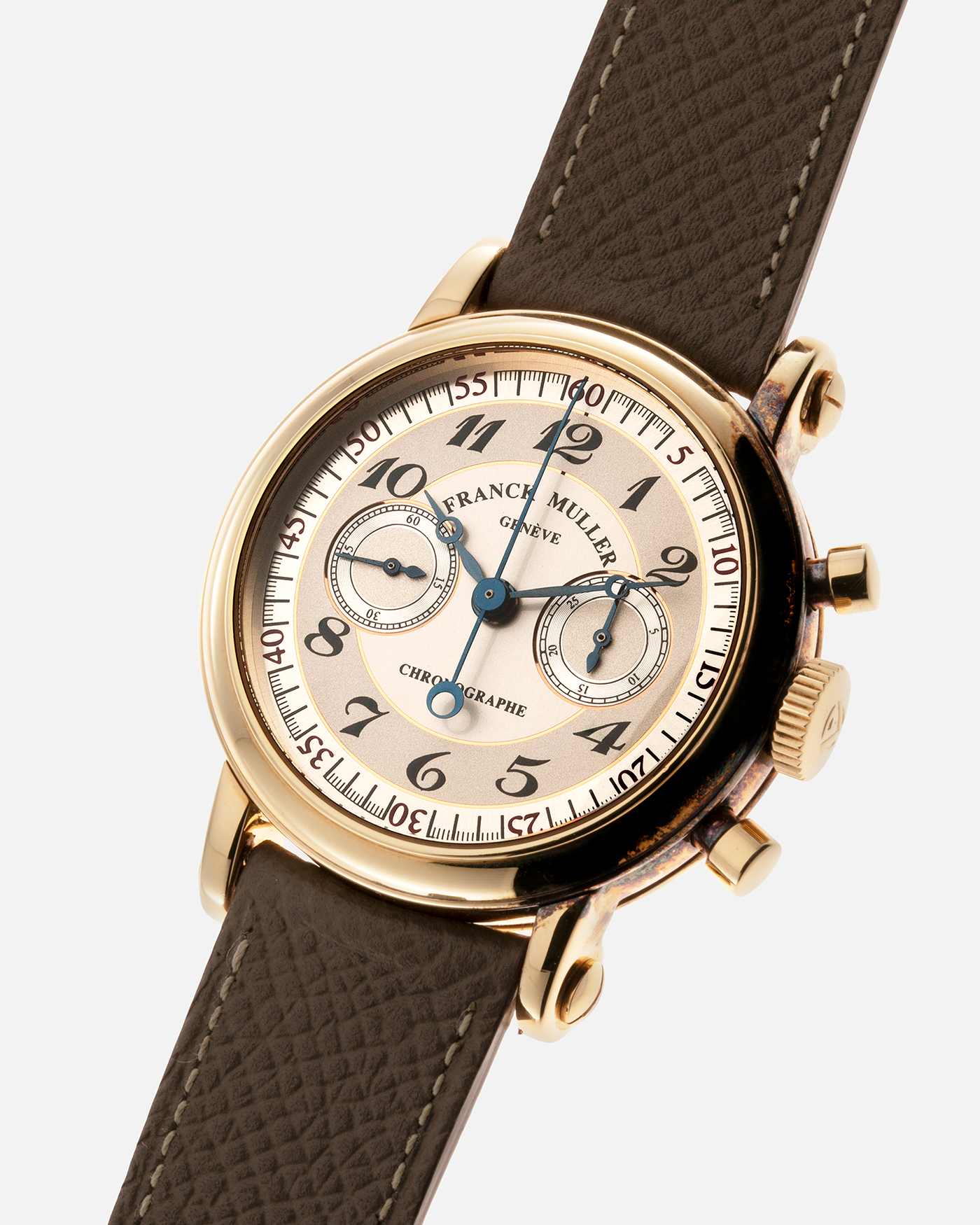 Brand: Franck Muller Year: 2000’s Model: Chronographe Double Face Reference: 2870 NA DF Material: 18-carat Yellow Gold Movement: Lemania Cal. 1872, Manual-Winding Case Diameter: 37mm Strap: Nostime Sand Tan Suede Calf Leather Strap with Signed 18-carat Tang Buckle, Additional Franck Muller Black Alligator Leather Strap.