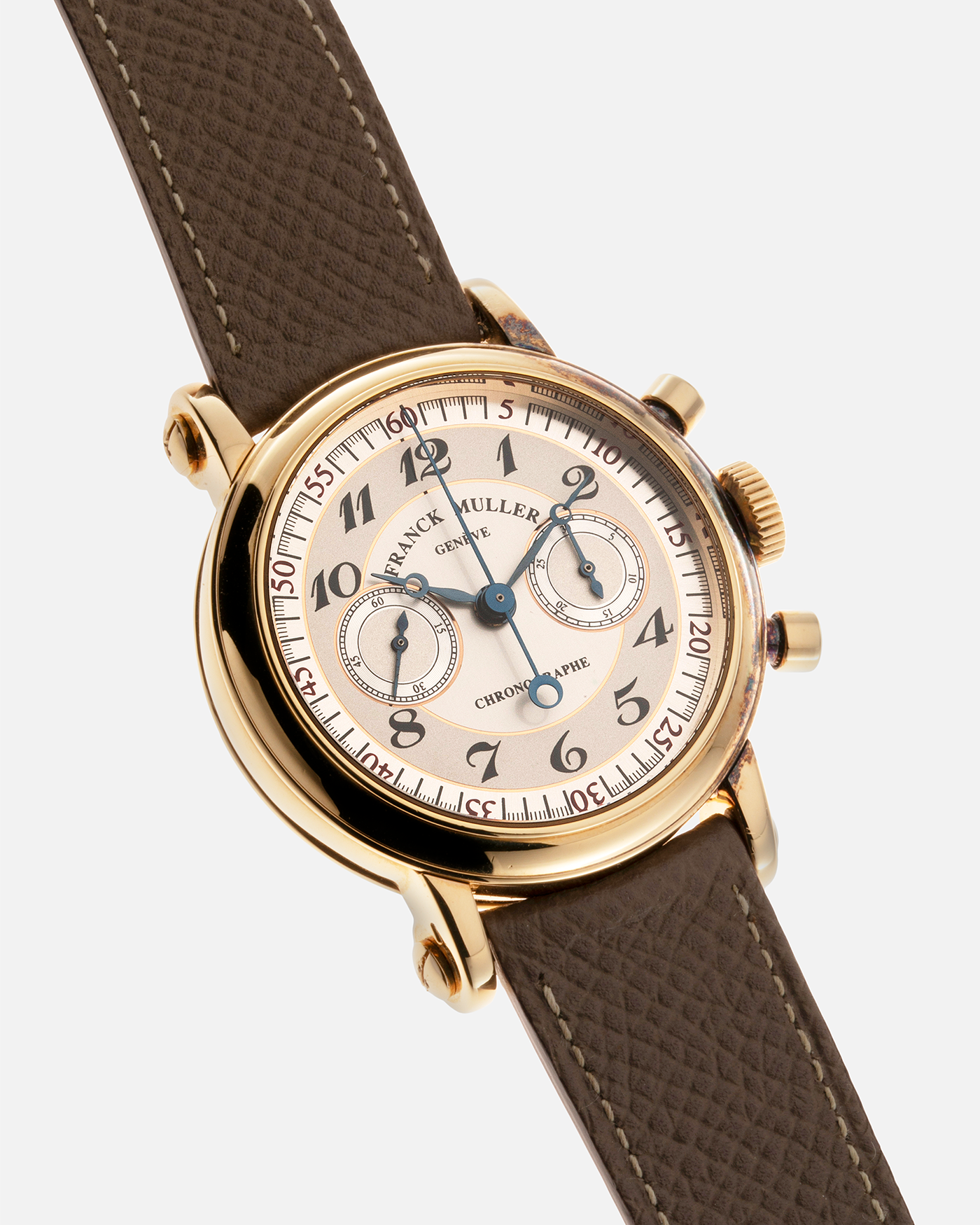 Brand: Franck Muller Year: 2000’s Model: Chronographe Double Face Reference: 2870 NA DF Material: 18-carat Yellow Gold Movement: Lemania Cal. 1872, Manual-Winding Case Diameter: 37mm Strap: Nostime Sand Tan Suede Calf Leather Strap with Signed 18-carat Tang Buckle, Additional Franck Muller Black Alligator Leather Strap.