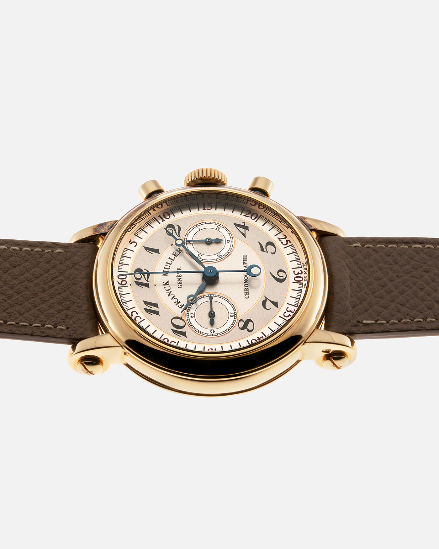 Brand: Franck Muller Year: 2000’s Model: Chronographe Double Face Reference: 2870 NA DF Material: 18-carat Yellow Gold Movement: Lemania Cal. 1872, Manual-Winding Case Diameter: 37mm Strap: Nostime Sand Tan Suede Calf Leather Strap with Signed 18-carat Tang Buckle, Additional Franck Muller Black Alligator Leather Strap.