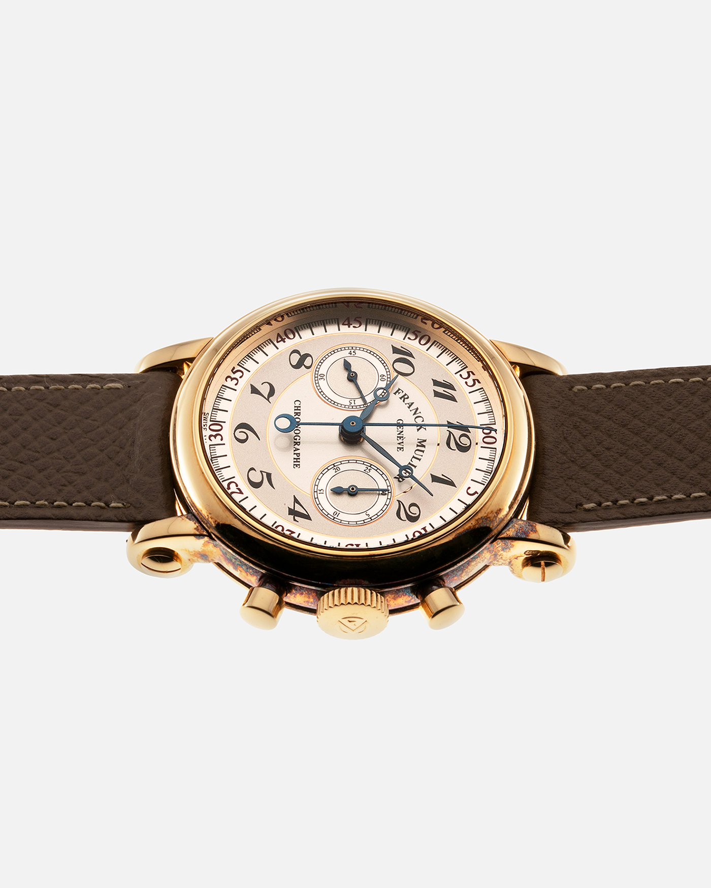 Brand: Franck Muller Year: 2000’s Model: Chronographe Double Face Reference: 2870 NA DF Material: 18-carat Yellow Gold Movement: Lemania Cal. 1872, Manual-Winding Case Diameter: 37mm Strap: Nostime Sand Tan Suede Calf Leather Strap with Signed 18-carat Tang Buckle, Additional Franck Muller Black Alligator Leather Strap.
