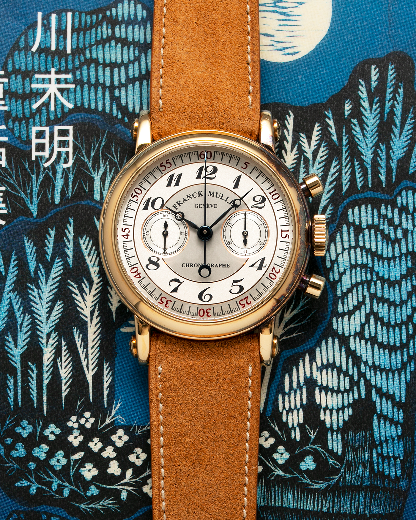 Brand: Franck Muller Year: 2000’s Model: Chronographe Double Face Reference: 2870 NA DF Material: 18-carat Yellow Gold Movement: Lemania Cal. 1872, Manual-Winding Case Diameter: 37mm Strap: Nostime Sand Tan Suede Calf Leather Strap with Signed 18-carat Tang Buckle, Additional Franck Muller Black Alligator Leather Strap.