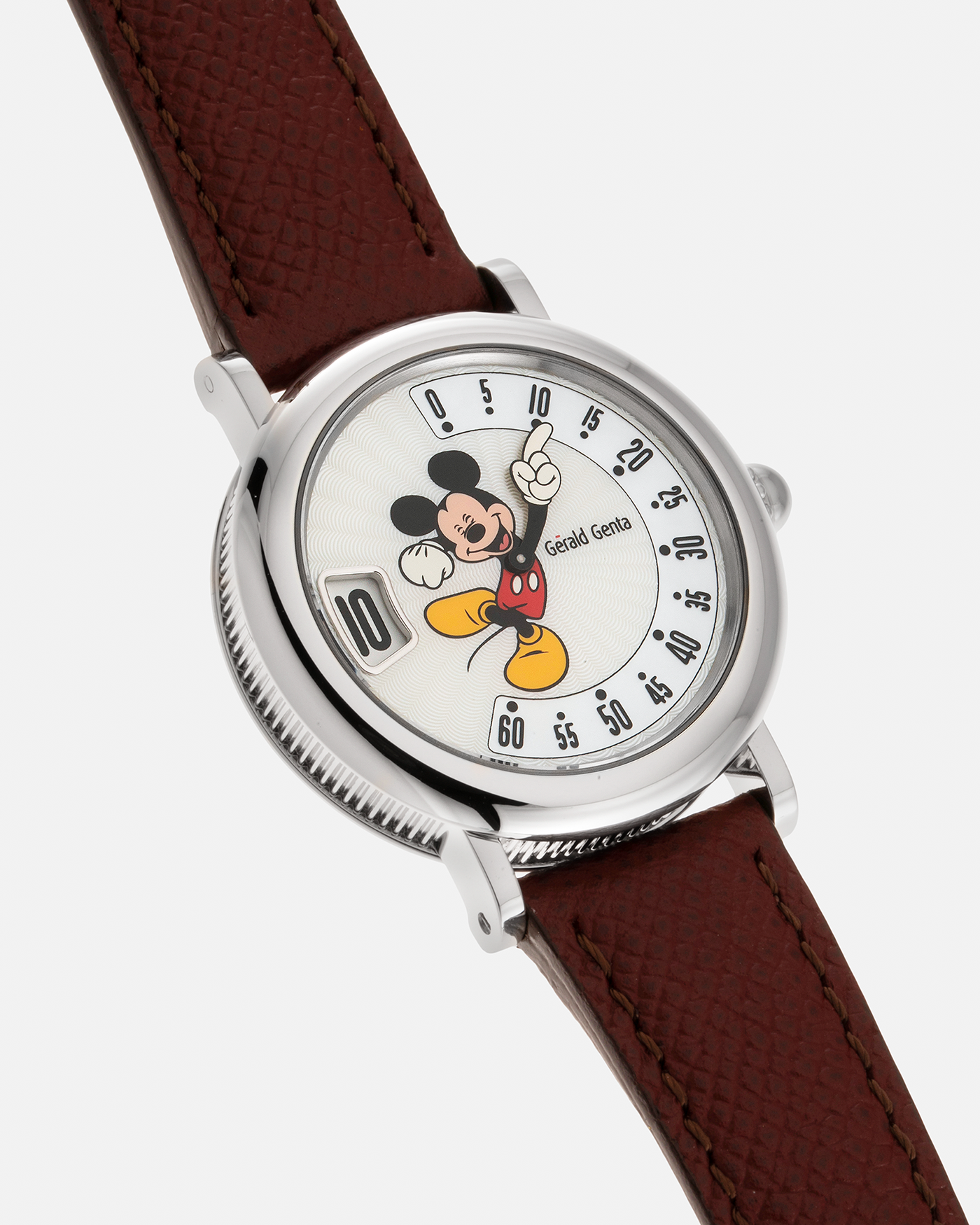 Brand: Gérald Genta Year: 2008 Model: Retro Fantasy ‘Mickey Mouse’ Reference Number: Ref.M.10.065.CR.BA Serial Number: 105XXX Material: Stainless Steel Case, Mother-of-Pearl dial Movement: Cal. ETA 2892A2, Self-Winding Case Diameter: 36mm Lug Width: 18mm Strap: Generic Oxblood Lizard Leather Strap with Signed Stainless Steel Tang Buckle, with additional Gérald Genta Burgundy Red Alligator Leather Strap