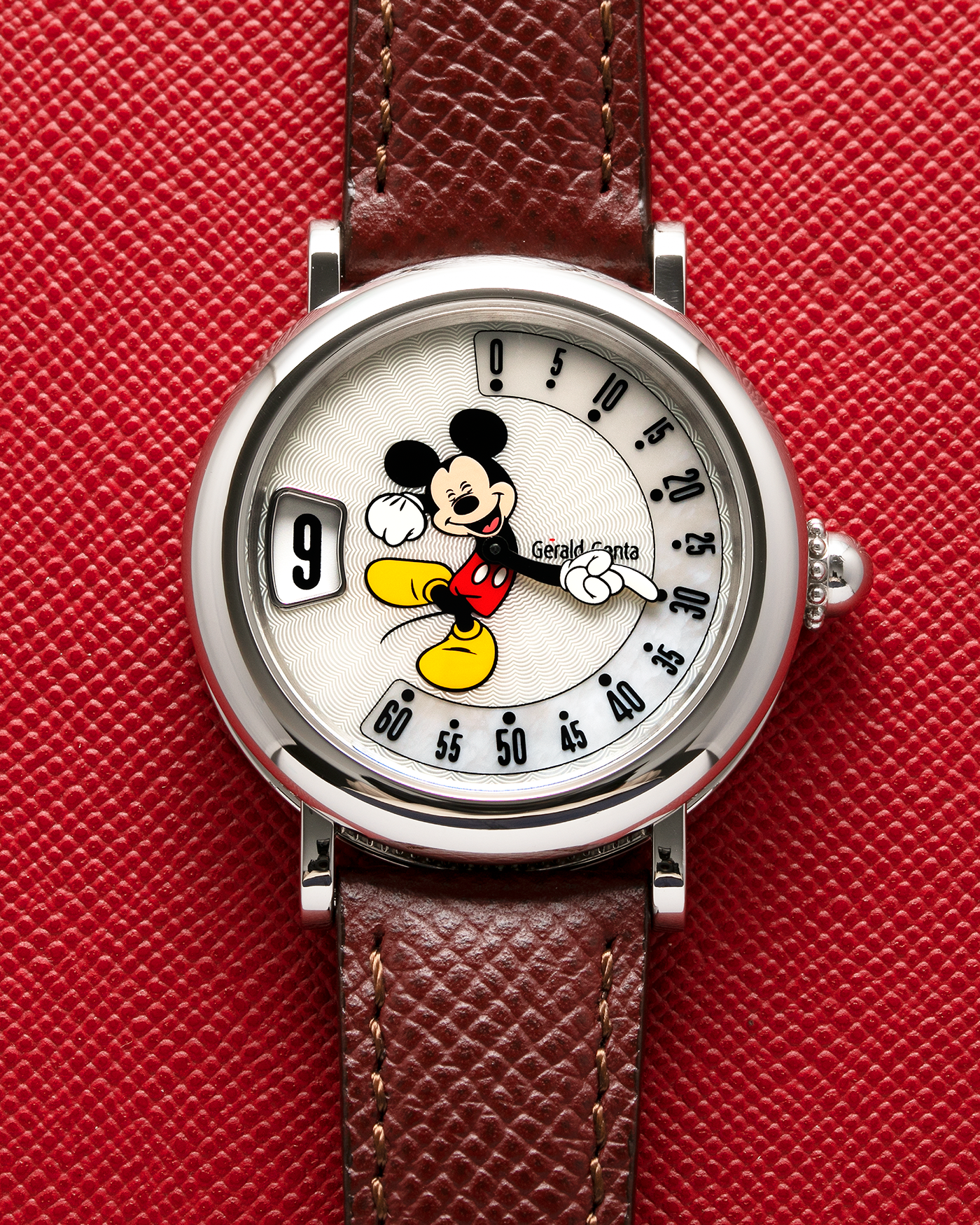 Brand: Gérald Genta Year: 2008 Model: Retro Fantasy ‘Mickey Mouse’ Reference Number: Ref.M.10.065.CR.BA Serial Number: 105XXX Material: Stainless Steel Case, Mother-of-Pearl dial Movement: Cal. ETA 2892A2, Self-Winding Case Diameter: 36mm Lug Width: 18mm Strap: Generic Oxblood Lizard Leather Strap with Signed Stainless Steel Tang Buckle, with additional Gérald Genta Burgundy Red Alligator Leather Strap
