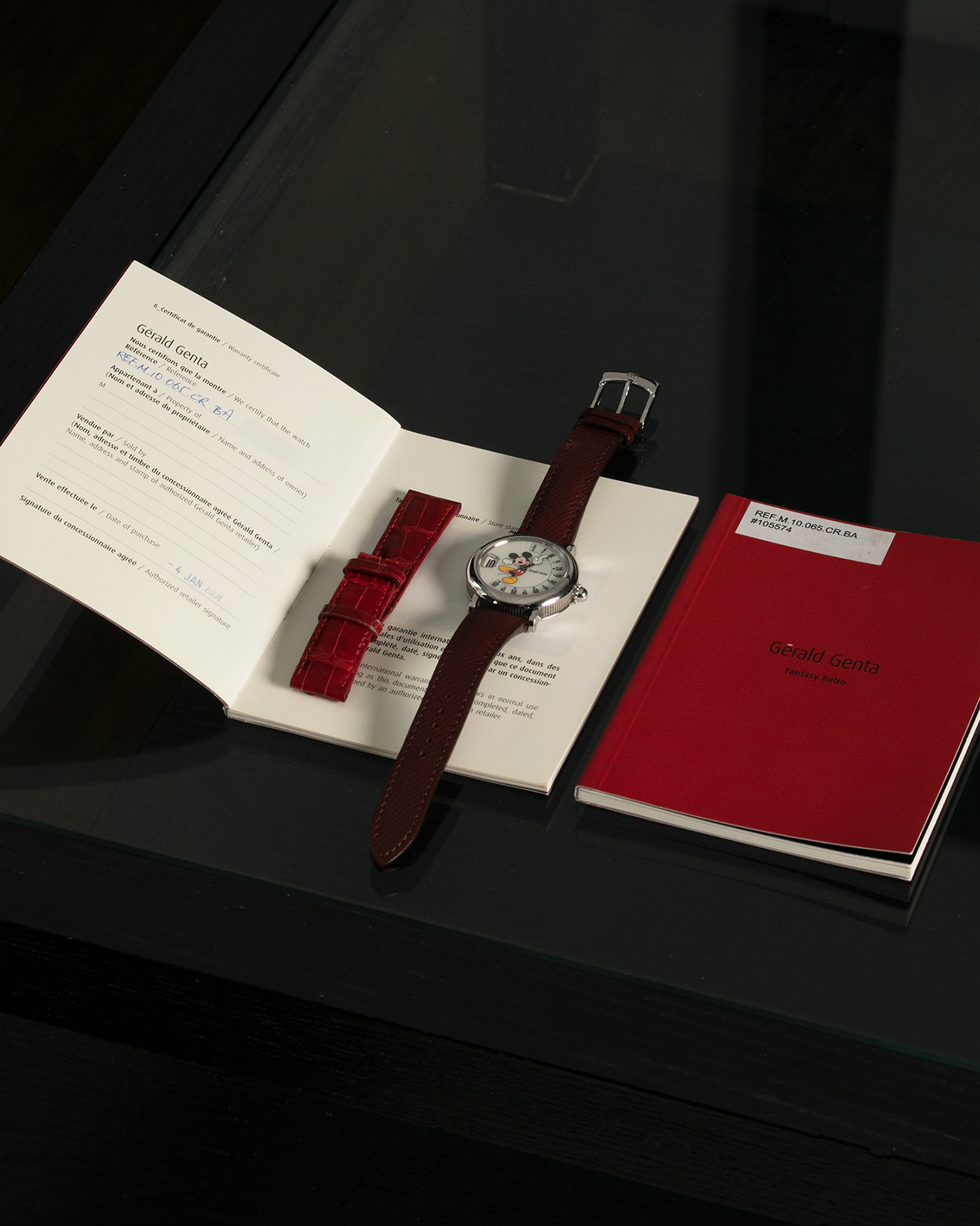 Brand: Gérald Genta Year: 2008 Model: Retro Fantasy ‘Mickey Mouse’ Reference Number: Ref.M.10.065.CR.BA Serial Number: 105XXX Material: Stainless Steel Case, Mother-of-Pearl dial Movement: Cal. ETA 2892A2, Self-Winding Case Diameter: 36mm Lug Width: 18mm Strap: Generic Oxblood Lizard Leather Strap with Signed Stainless Steel Tang Buckle, with additional Gérald Genta Burgundy Red Alligator Leather Strap
