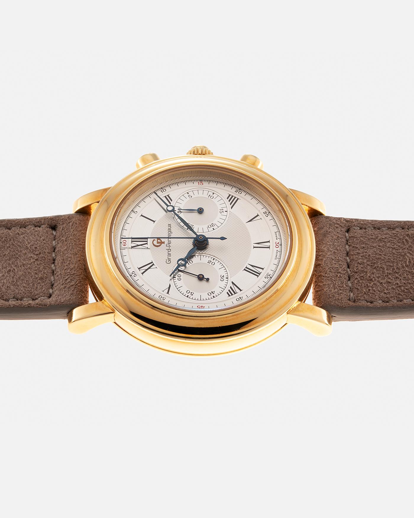 Brand: Girard Perregaux Year: 1990’s Reference Number: 47930 Material: 18k Yellow Gold Movement: Lemania Cal. 1872  Case Diameter: 38mm Strap: Molequin Taupe Suede Strap and 18k Yellow Gold Girard Perregaux Tan Buckle