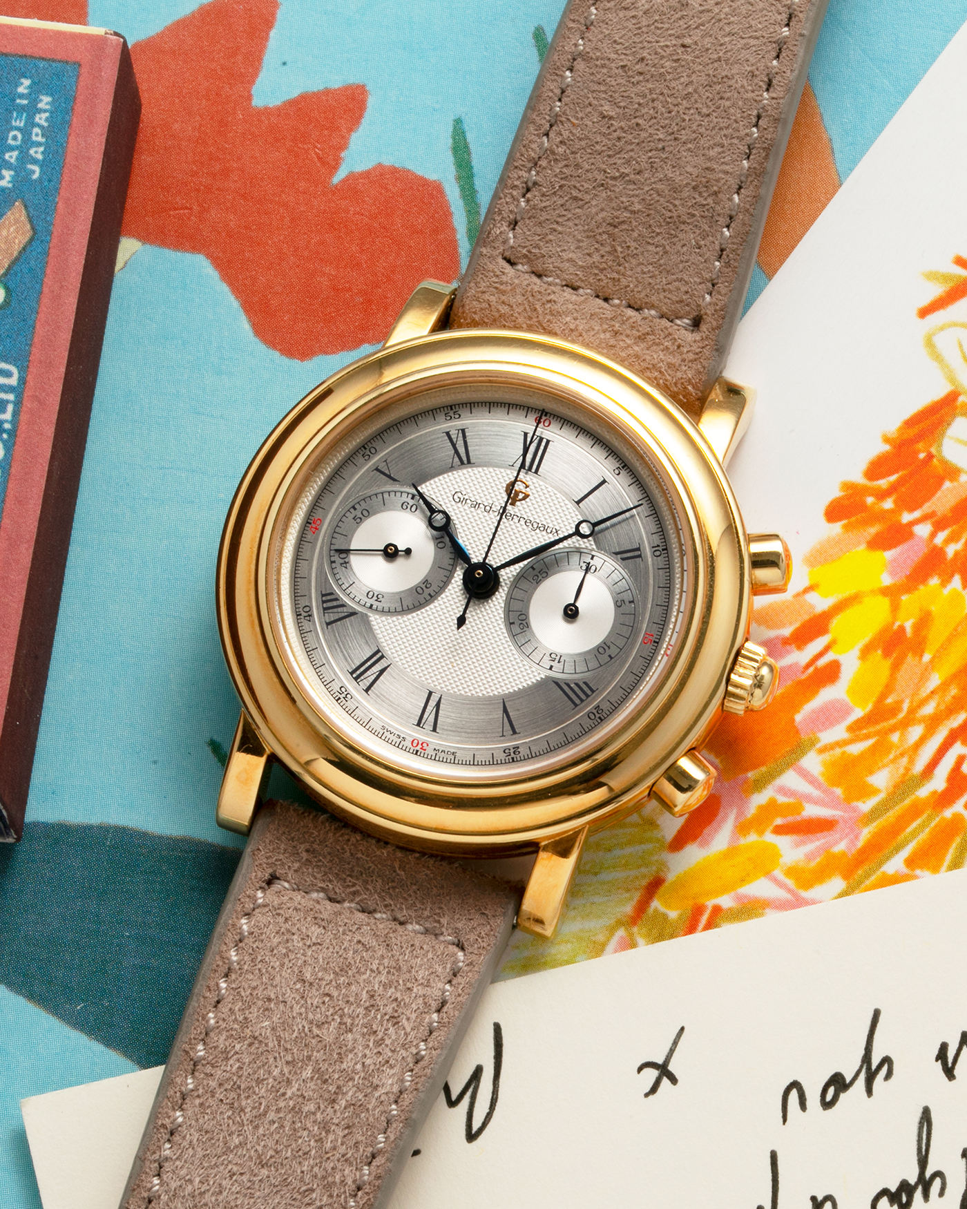 Brand: Girard Perregaux Year: 1990’s Reference Number: 47930 Material: 18k Yellow Gold Movement: Lemania Cal. 1872  Case Diameter: 38mm Strap: Molequin Taupe Suede Strap and 18k Yellow Gold Girard Perregaux Tan Buckle