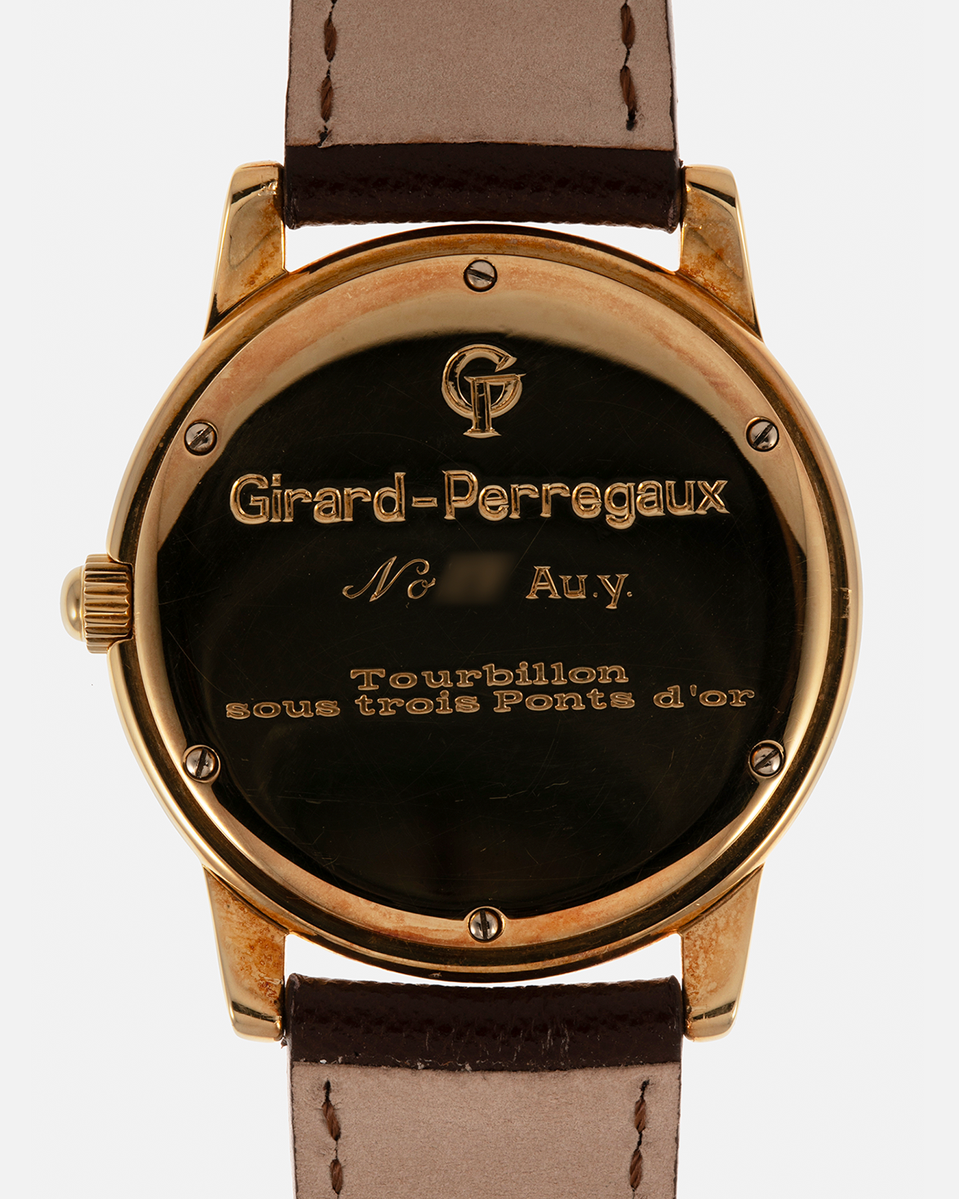 Brand: Girard Perregaux  Year: Mid-1990s Model: Three Bridges Tourbillon, “Tourbillon Sous Trois Ponts d'Or” Reference: 99000 Material: 18-carat Yellow Gold  Movement: Girard Perregaux Cal. 9910 Tourbillon, Manual-Winding  Case Dimensions: 39mm x 10.5mm (Lug-to-Lug 44.5mm)  Lug Width: 20mm  Strap: Phillips Dark Brown Textured Calf Leather Strap with Signed 18-carat Yellow Gold Tang Buckle 