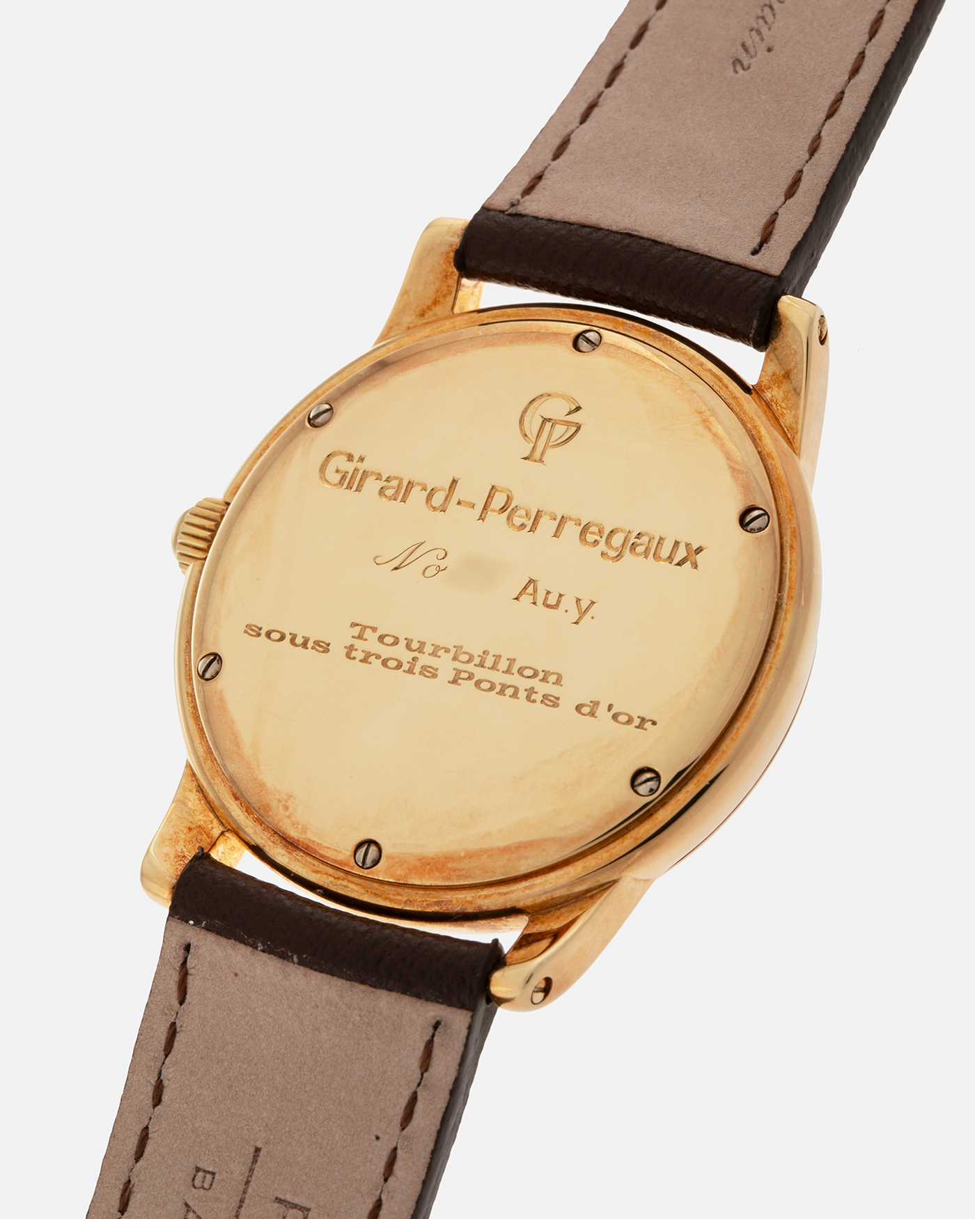 Brand: Girard Perregaux  Year: Mid-1990s Model: Three Bridges Tourbillon, “Tourbillon Sous Trois Ponts d'Or” Reference: 99000 Material: 18-carat Yellow Gold  Movement: Girard Perregaux Cal. 9910 Tourbillon, Manual-Winding  Case Dimensions: 39mm x 10.5mm (Lug-to-Lug 44.5mm)  Lug Width: 20mm  Strap: Phillips Dark Brown Textured Calf Leather Strap with Signed 18-carat Yellow Gold Tang Buckle 