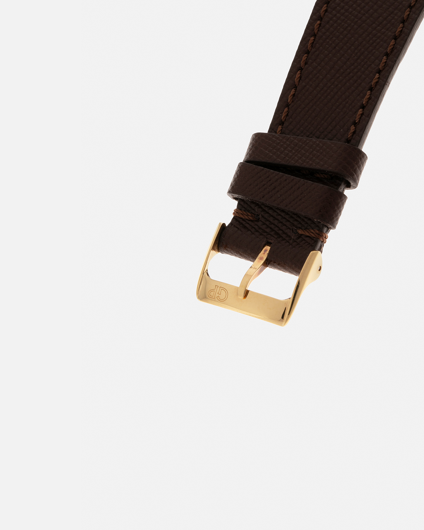 Brand: Girard Perregaux  Year: Mid-1990s Model: Three Bridges Tourbillon, “Tourbillon Sous Trois Ponts d'Or” Reference: 99000 Material: 18-carat Yellow Gold  Movement: Girard Perregaux Cal. 9910 Tourbillon, Manual-Winding  Case Dimensions: 39mm x 10.5mm (Lug-to-Lug 44.5mm)  Lug Width: 20mm  Strap: Phillips Dark Brown Textured Calf Leather Strap with Signed 18-carat Yellow Gold Tang Buckle 